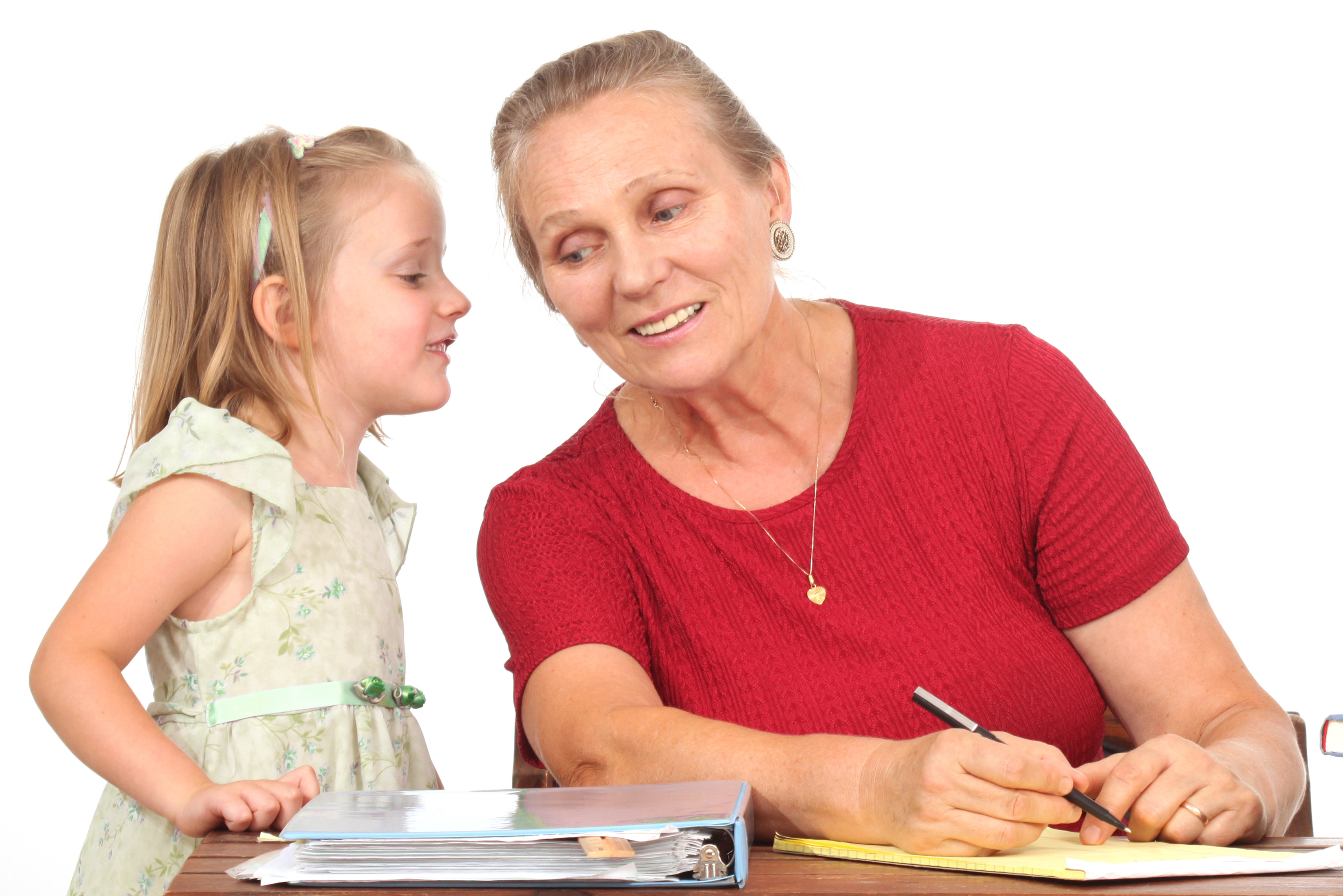 An older woman and a little girl whispering in her ear | Source: Shutterstock