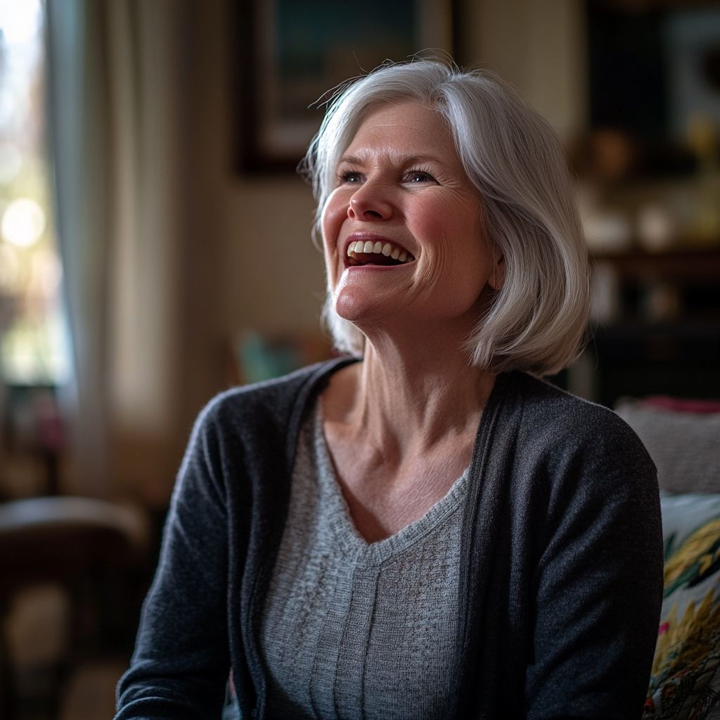 A senior woman laughs slyly while looking at someone | Source: No source
