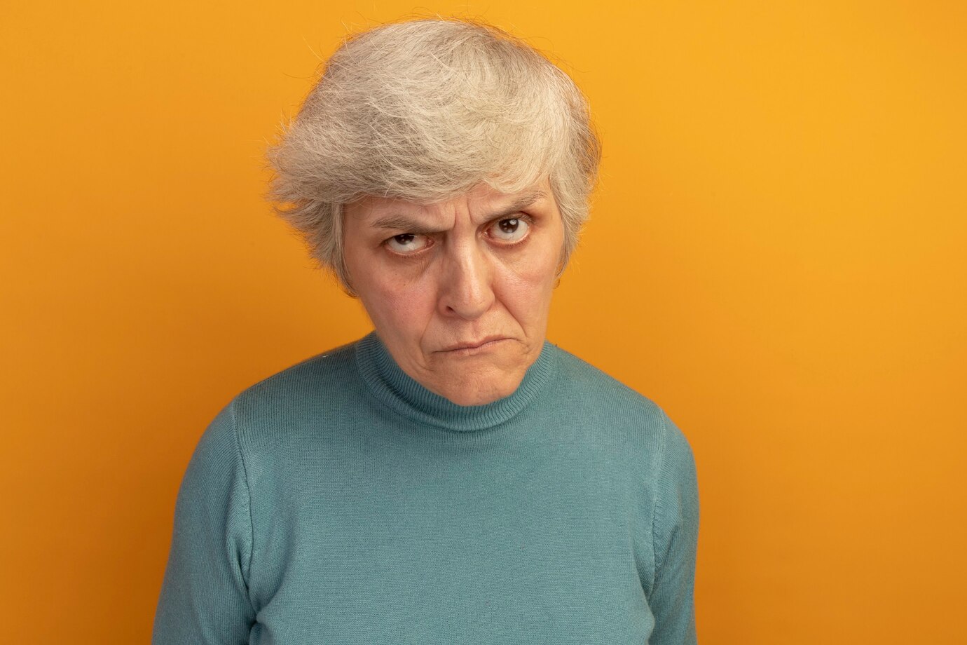 A frowning elderly woman | Source: Freepik