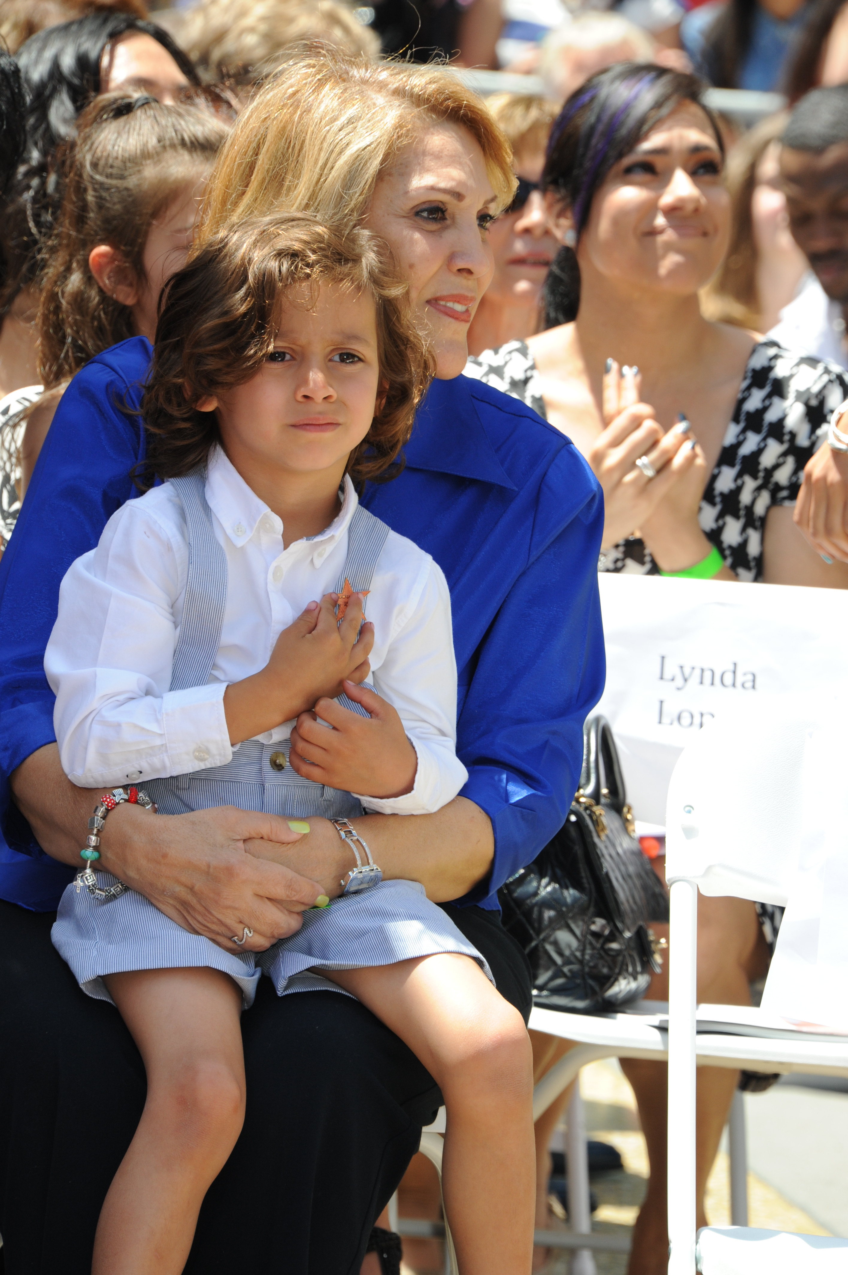 Maximilian Muniz with his grandmother Guadalupe Rodriguez as Jennifer Lopez is honored with a star on the Hollywood Walk of Fame on June 20, 2013 | Source: Getty Images