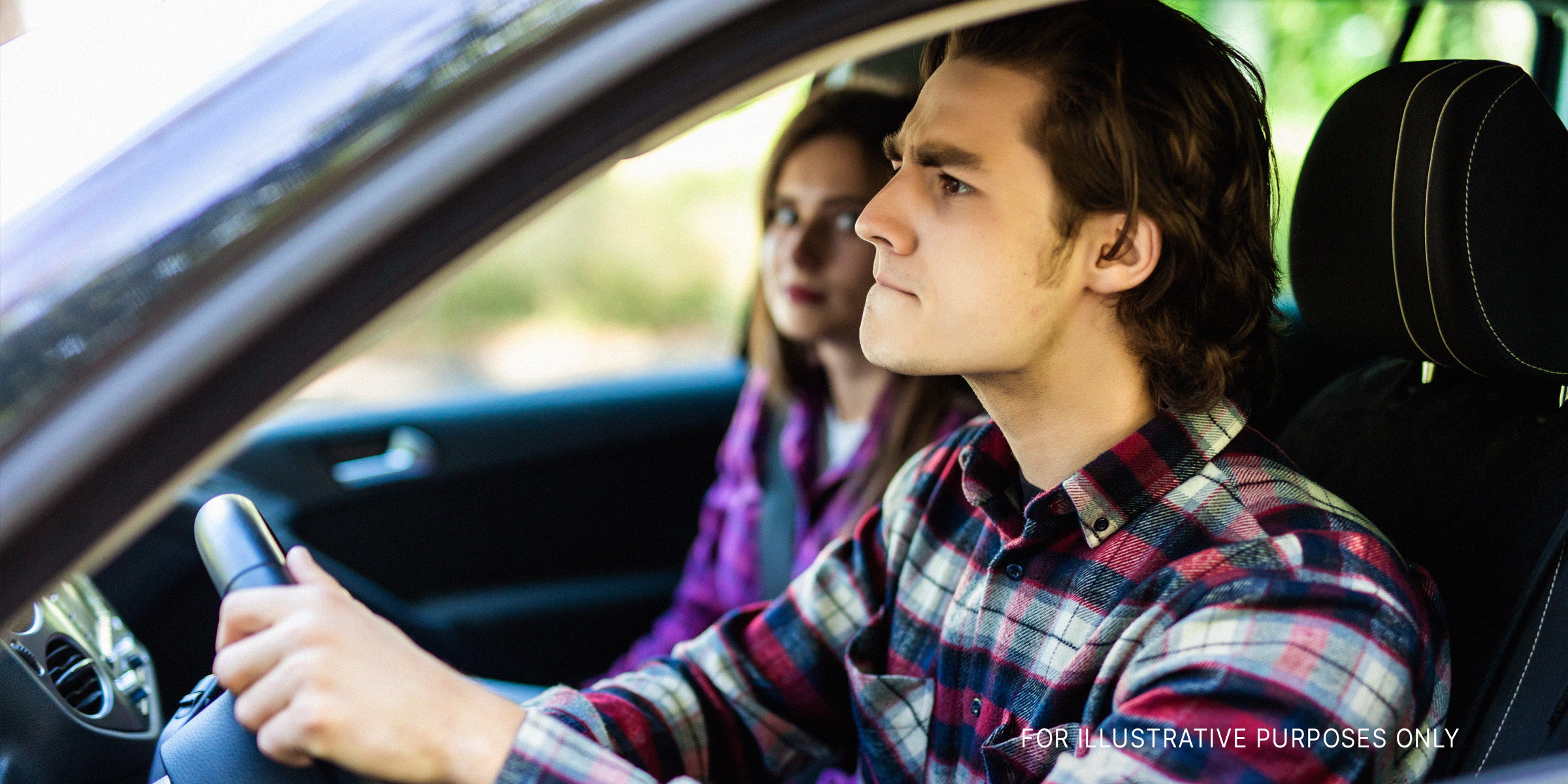 Beautiful couple having an argument in the car while driving | Source: Shutterstock