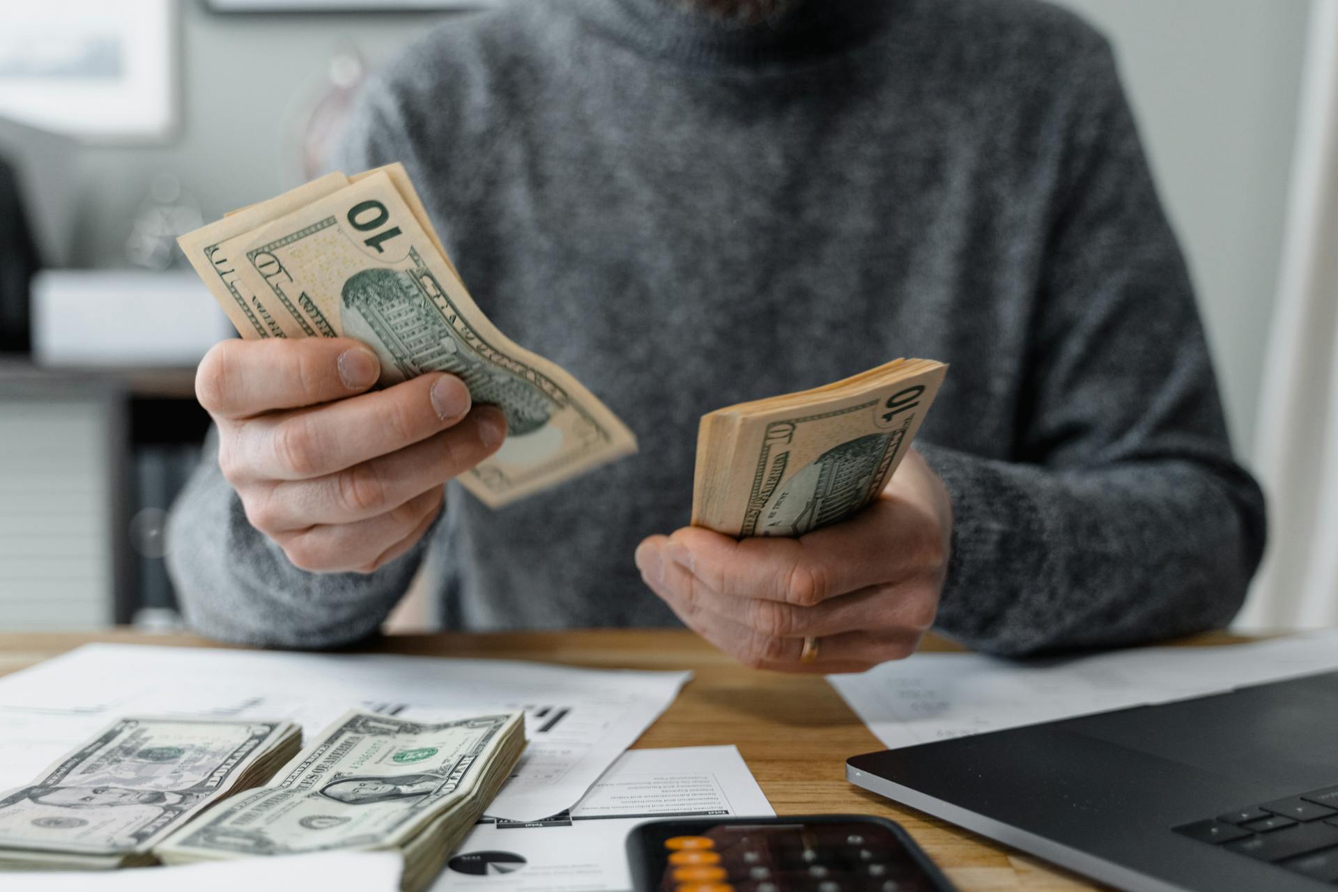 Person counting money | Source: Pexels