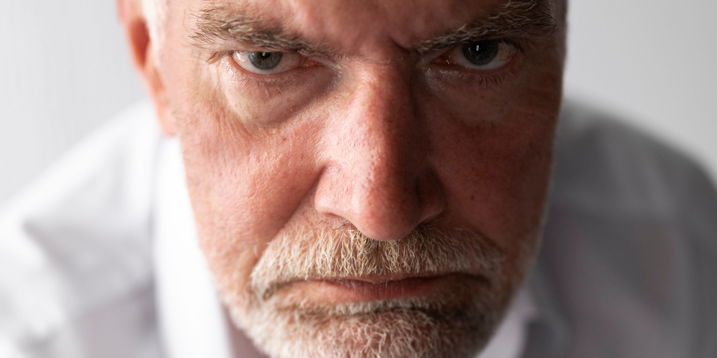 A close-up of a grumpy old man | Source: Freepik
