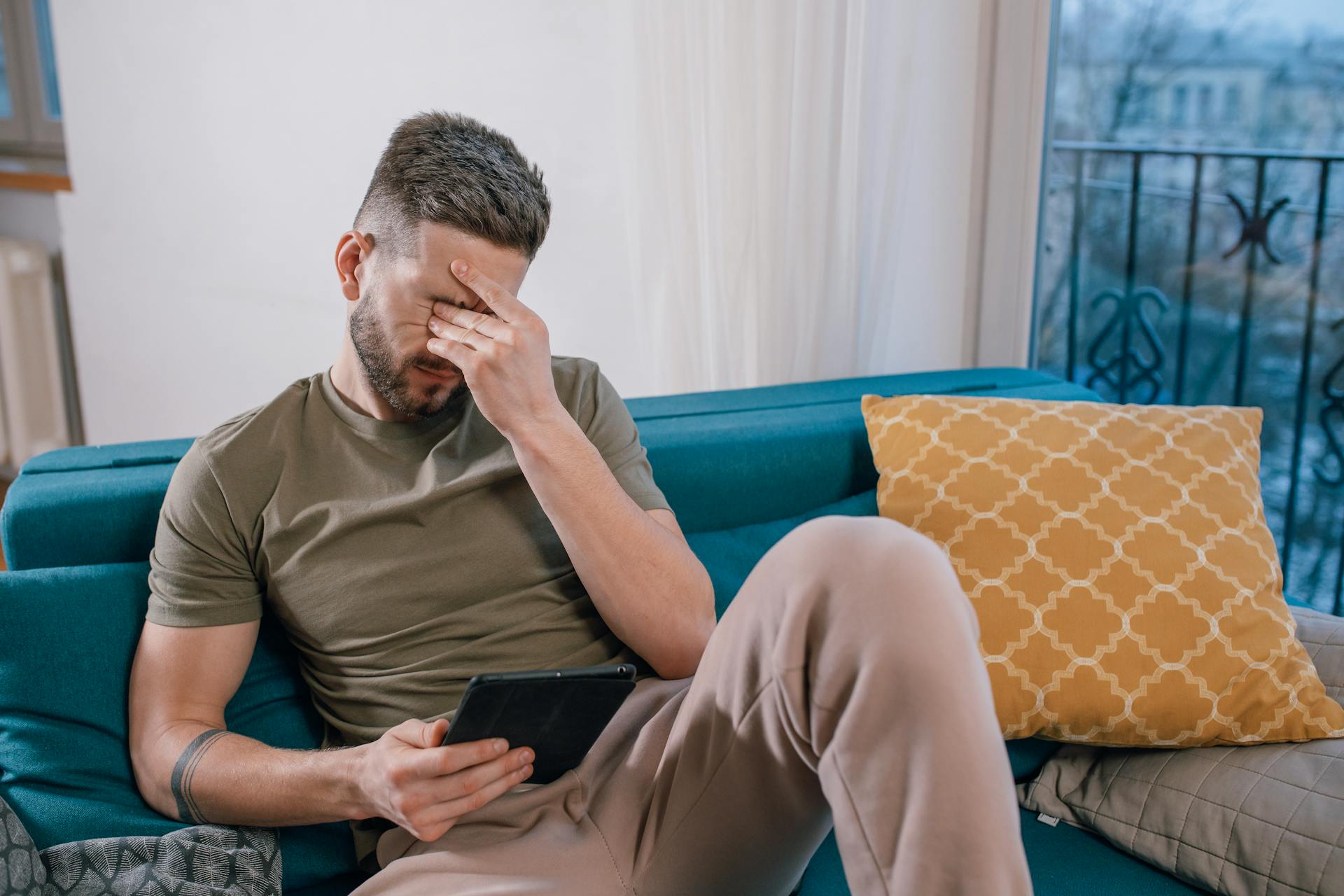 A disheartened man sitting on the couch | Source: Pexels