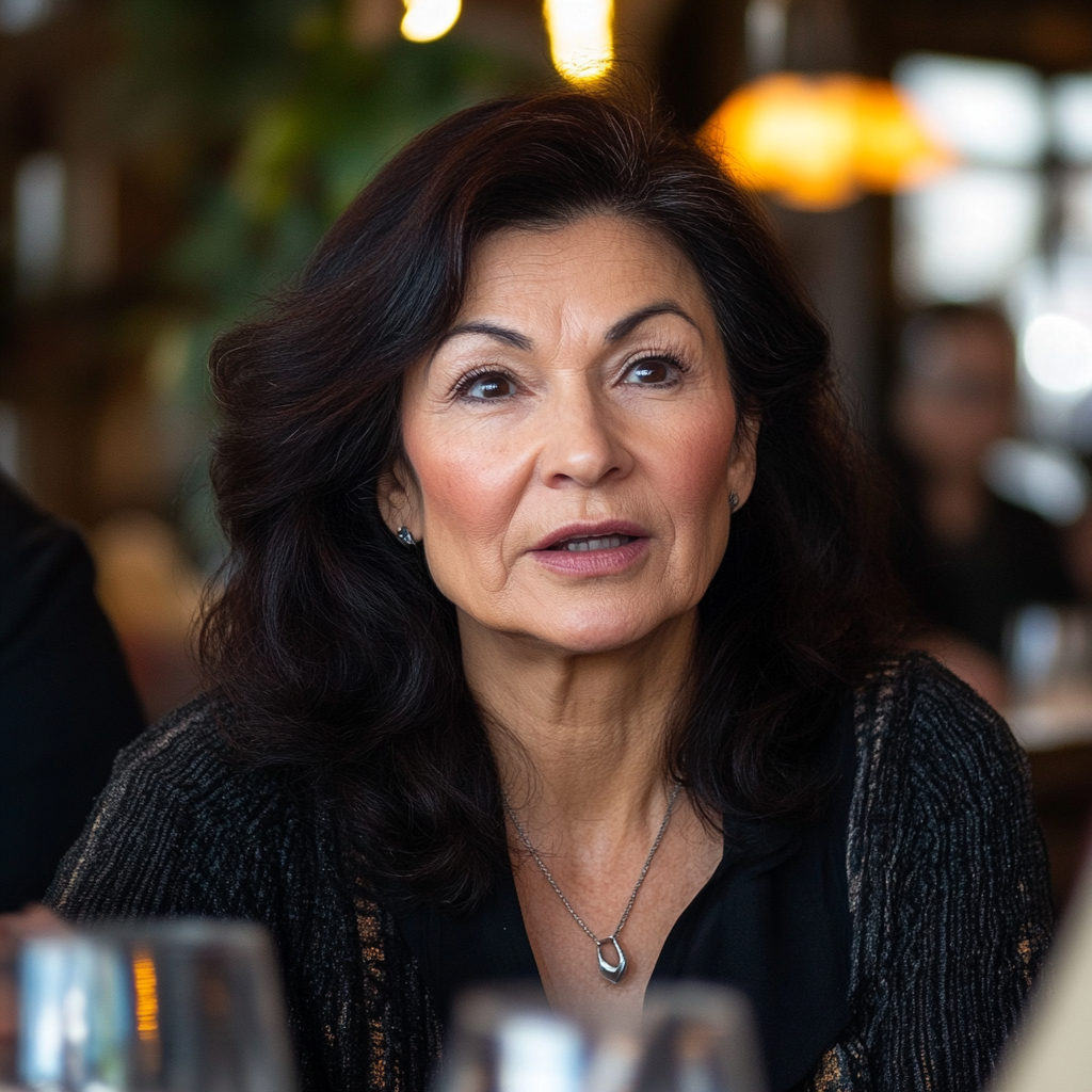 A woman speaking seriously in a restaurant | Source: No source