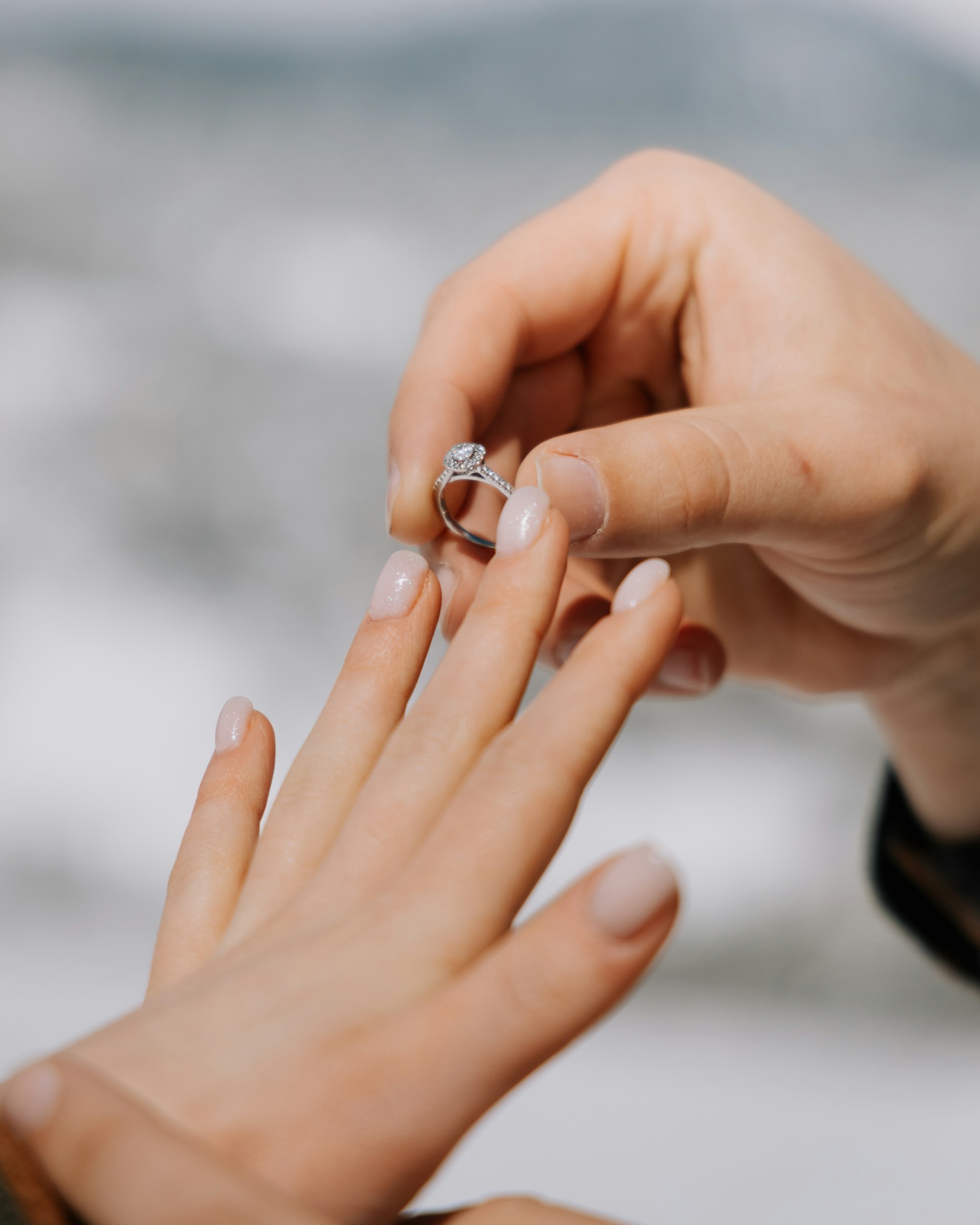 A man slipping a ring onto his partner's finger | Source: Unsplash