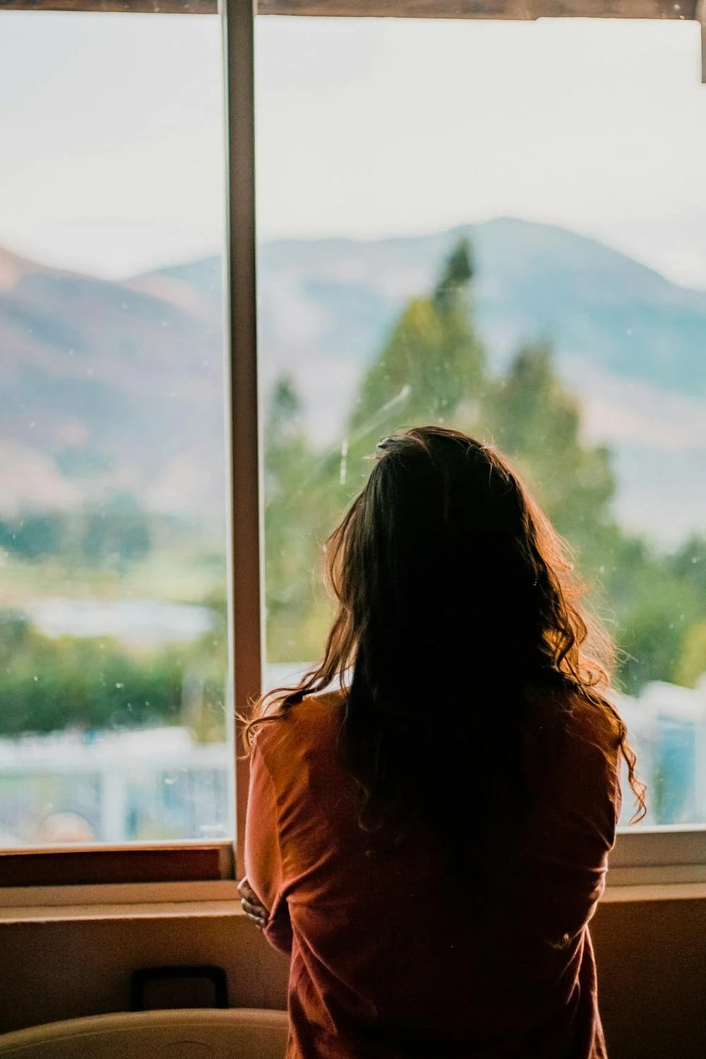 A woman looking out of her window | Source: Pexels