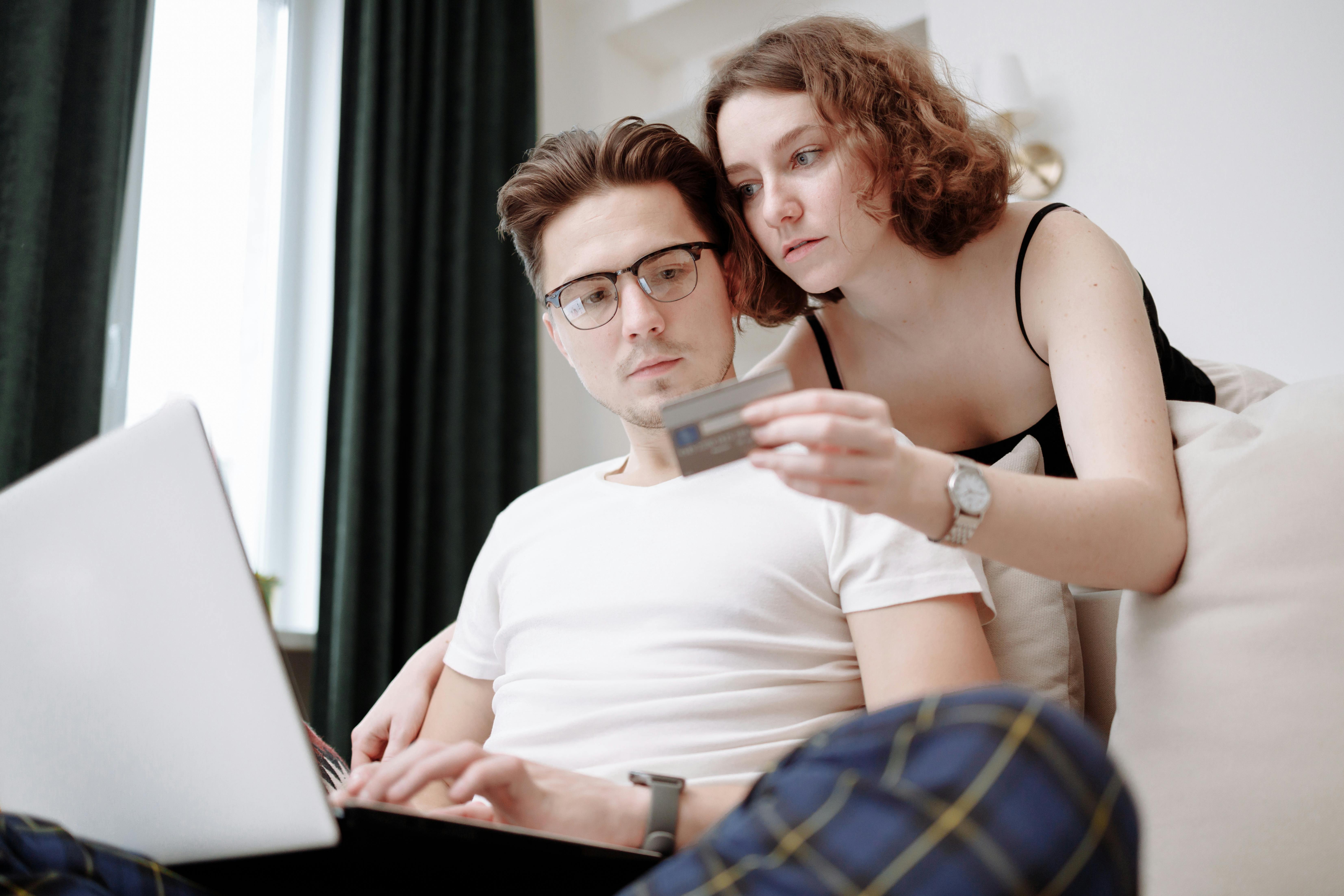 Man and woman in front of a laptop with a credit card | Source: Pexels