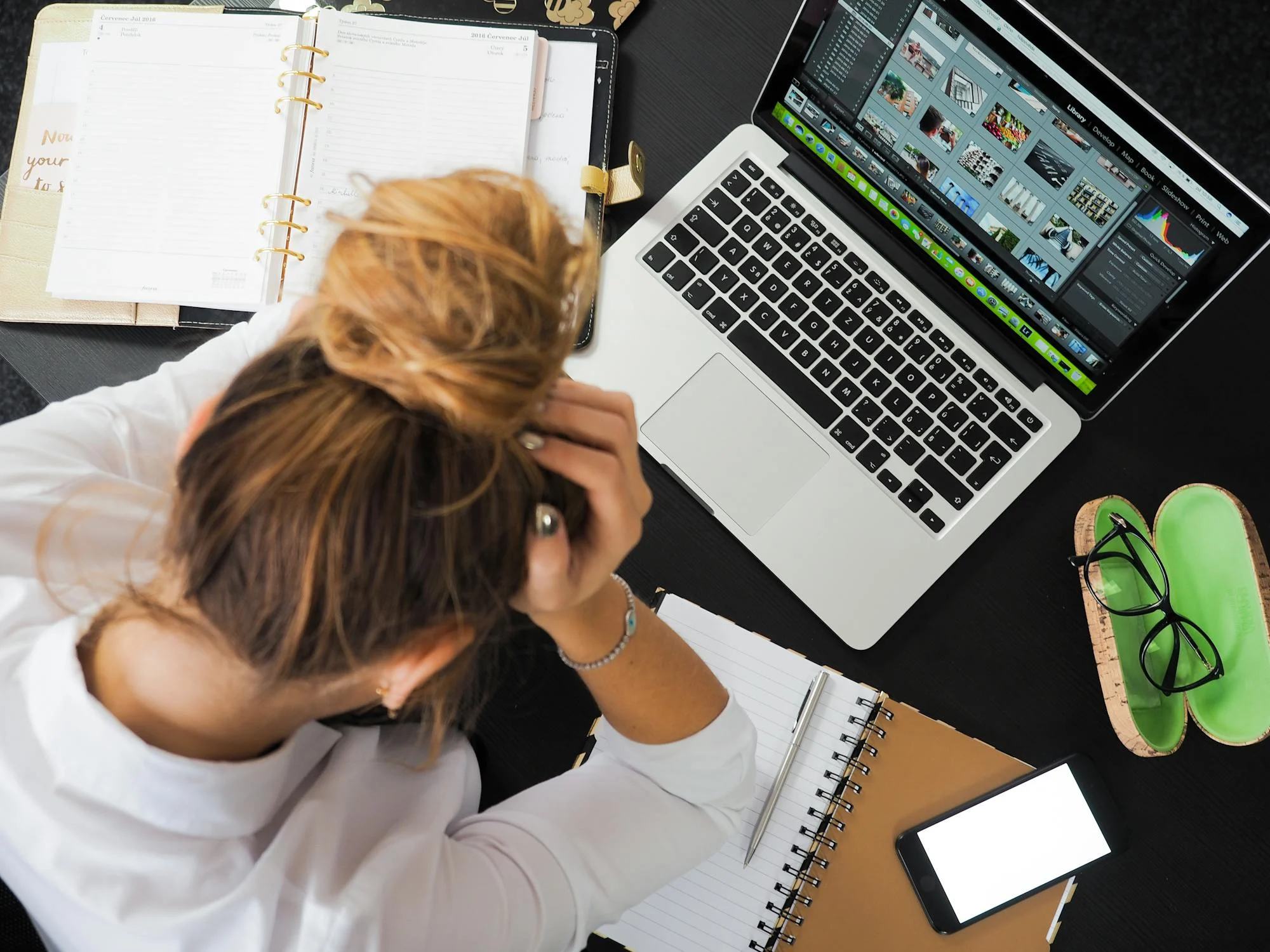 A tired woman looking at her laptop | Source: Pexels