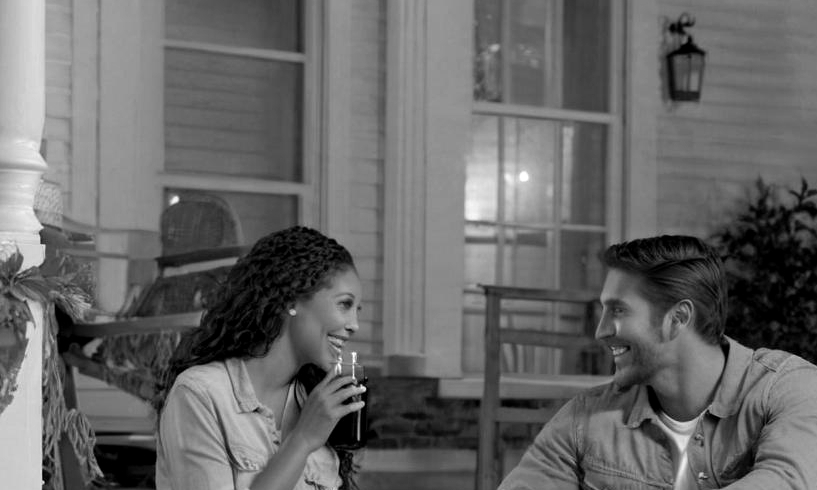 A happy couple conversing on a front porch | Source: no source