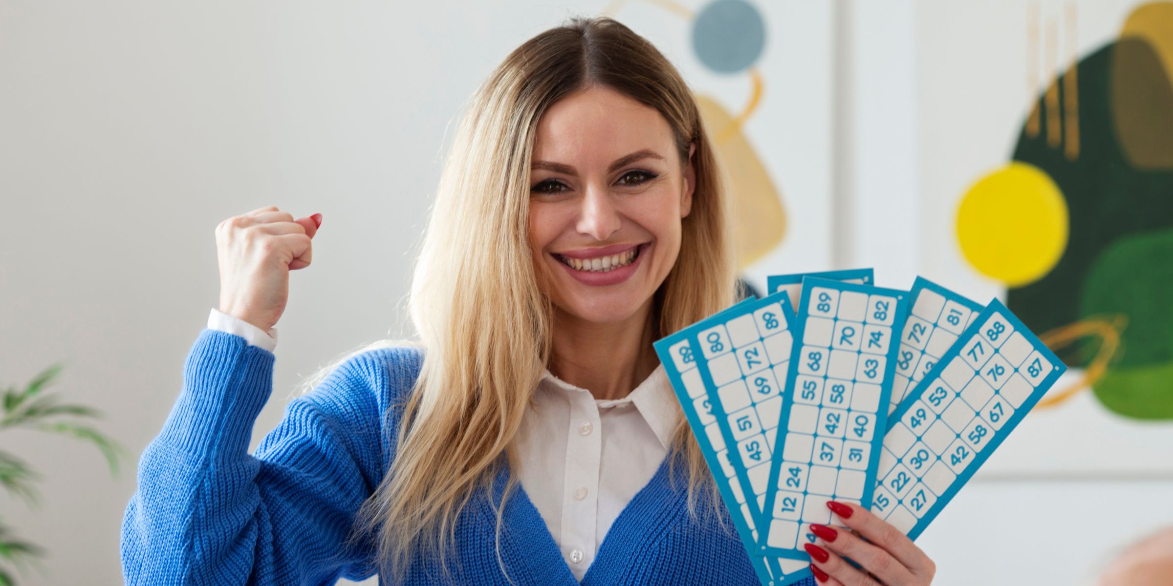 A happy woman holding lottery tickets | Source: No source