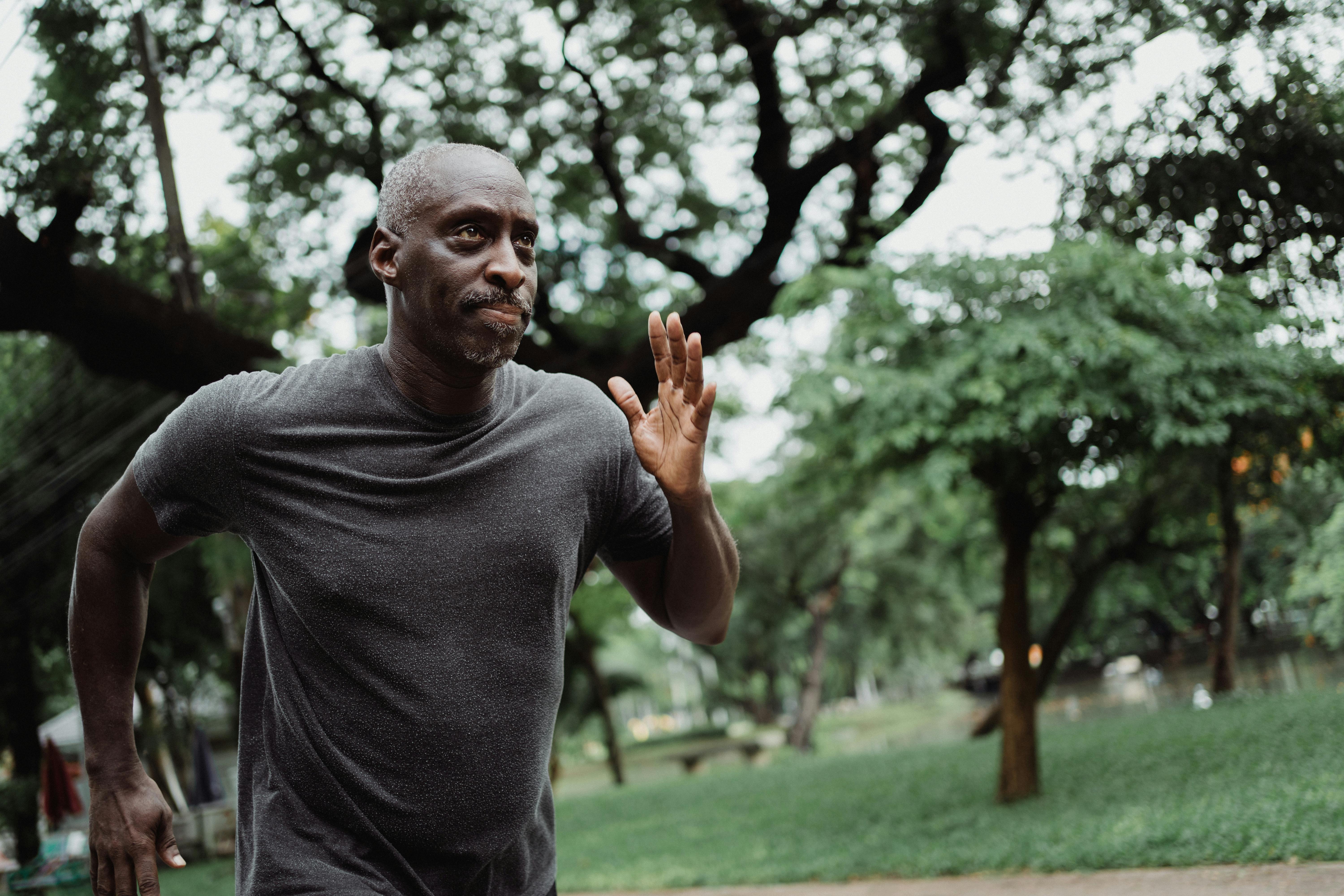 A man jogging with a focused expression, emphasizing dedication to physical fitness and health | Source: Pexels