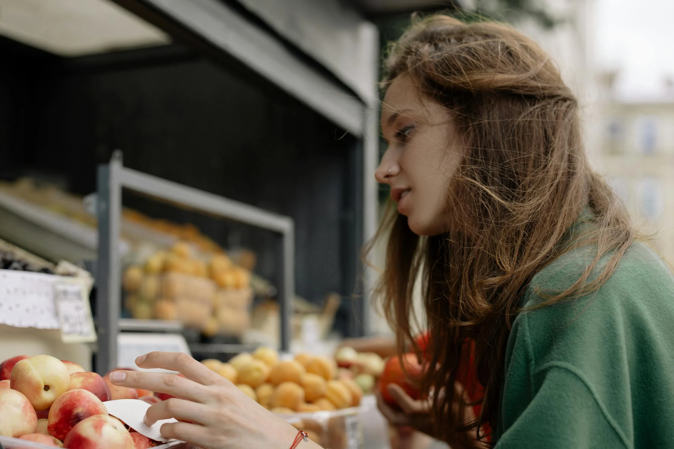 A woman picking fruit | Source: Pexels