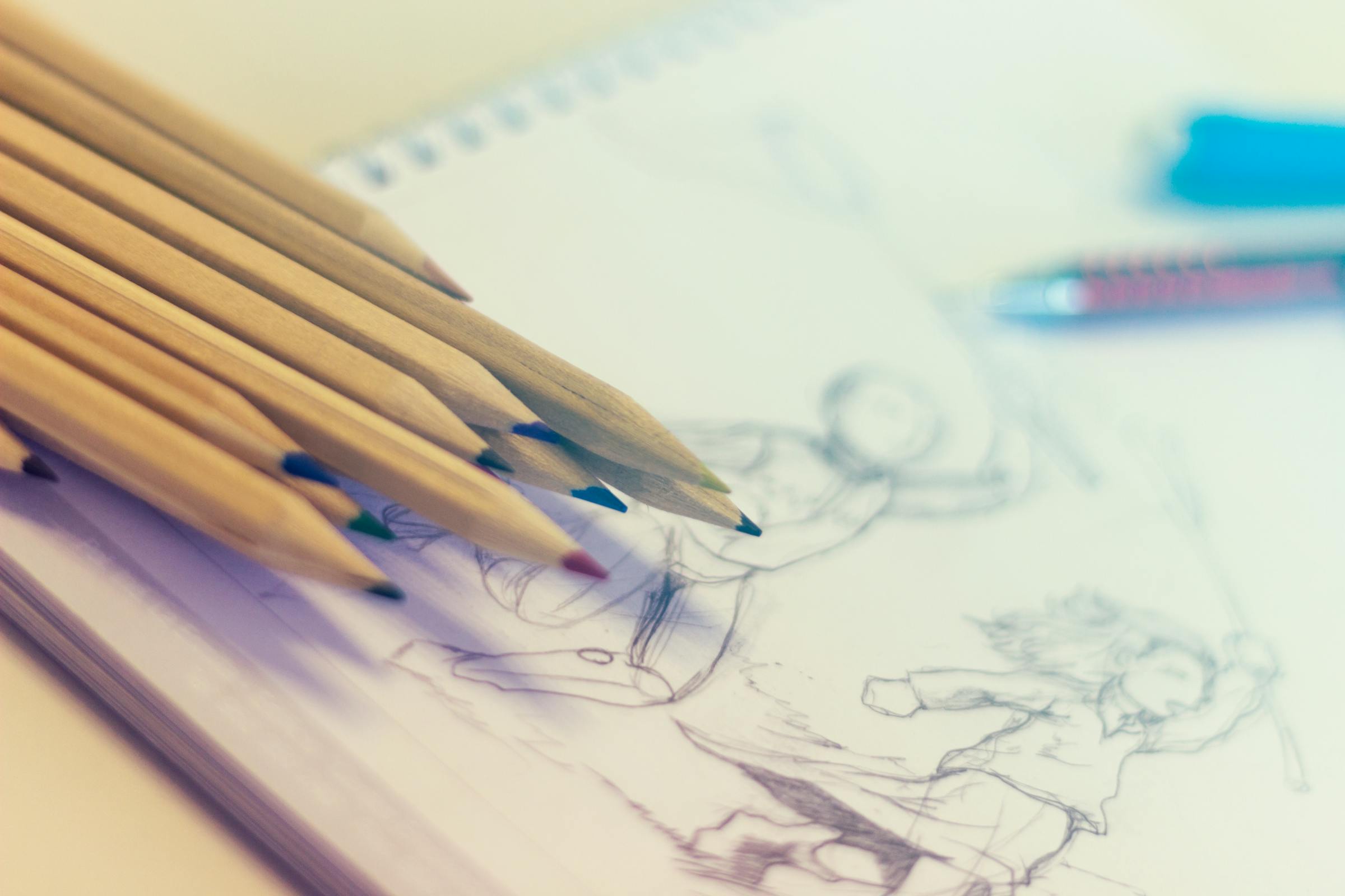 Pencils on top of sketchbook | Source: Pexels