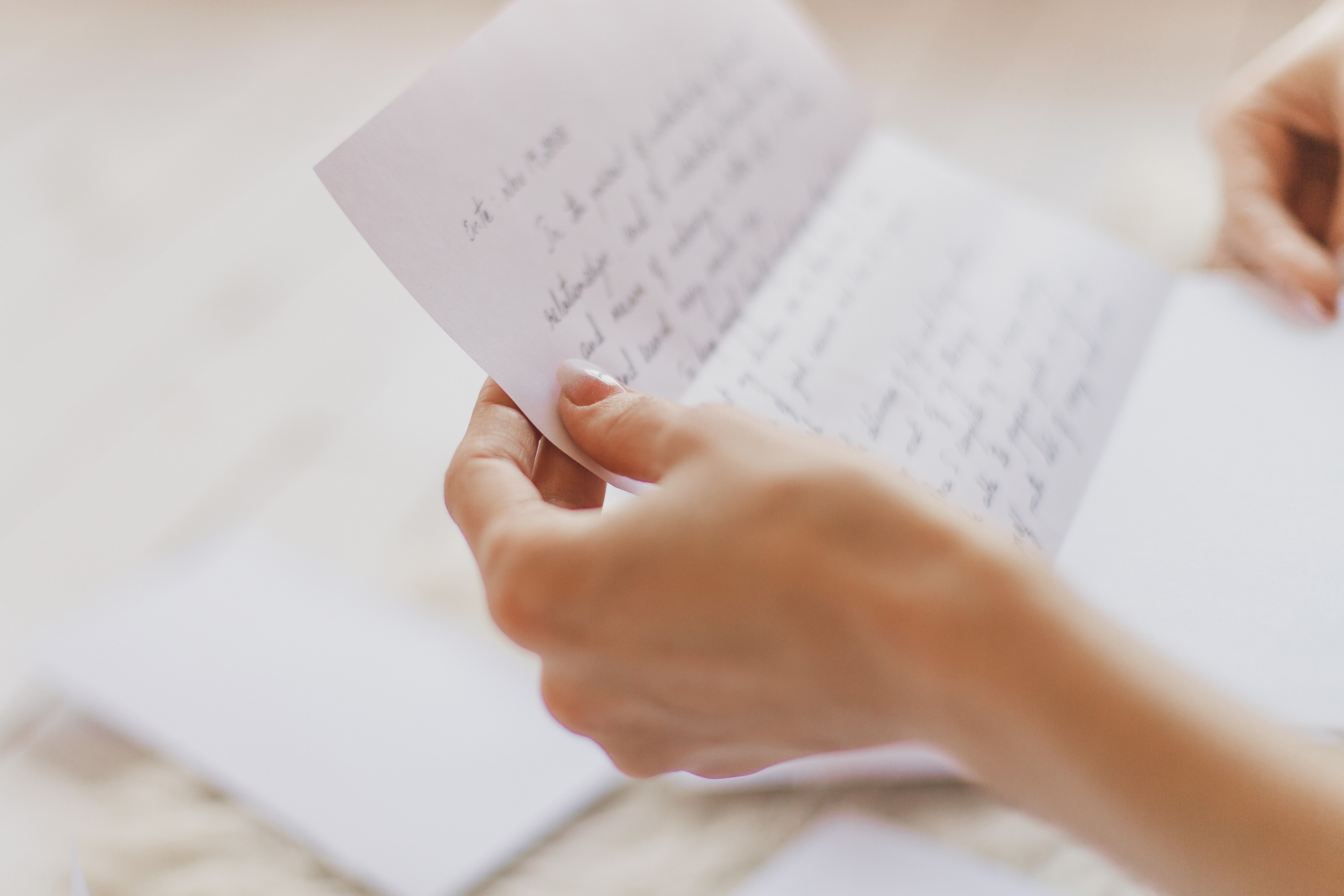 Woman holds letter | Source: Shutterstock