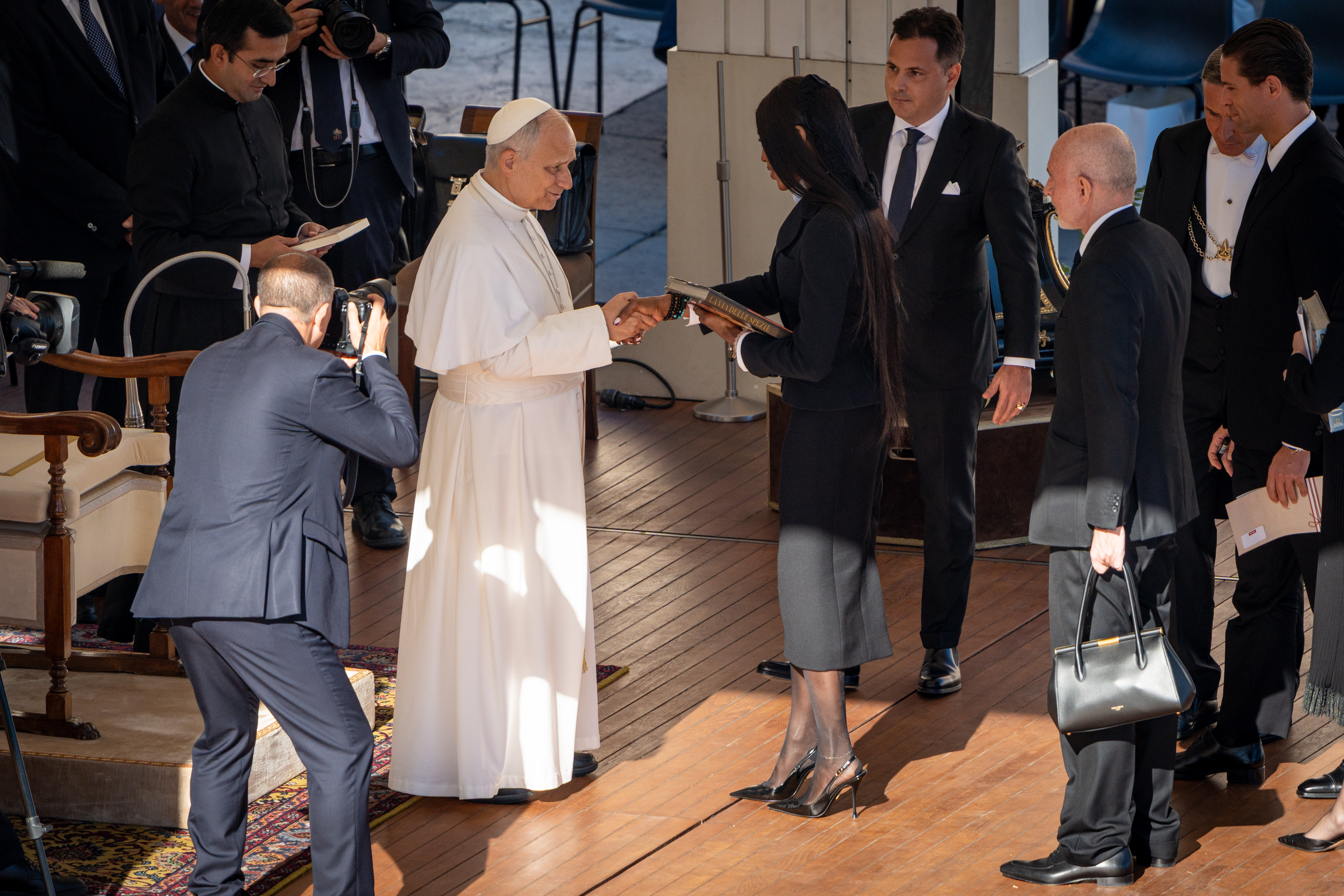 Naomi Campbell holding the book as she shakes hands with Pope Leo XIV. | Source: Getty Images