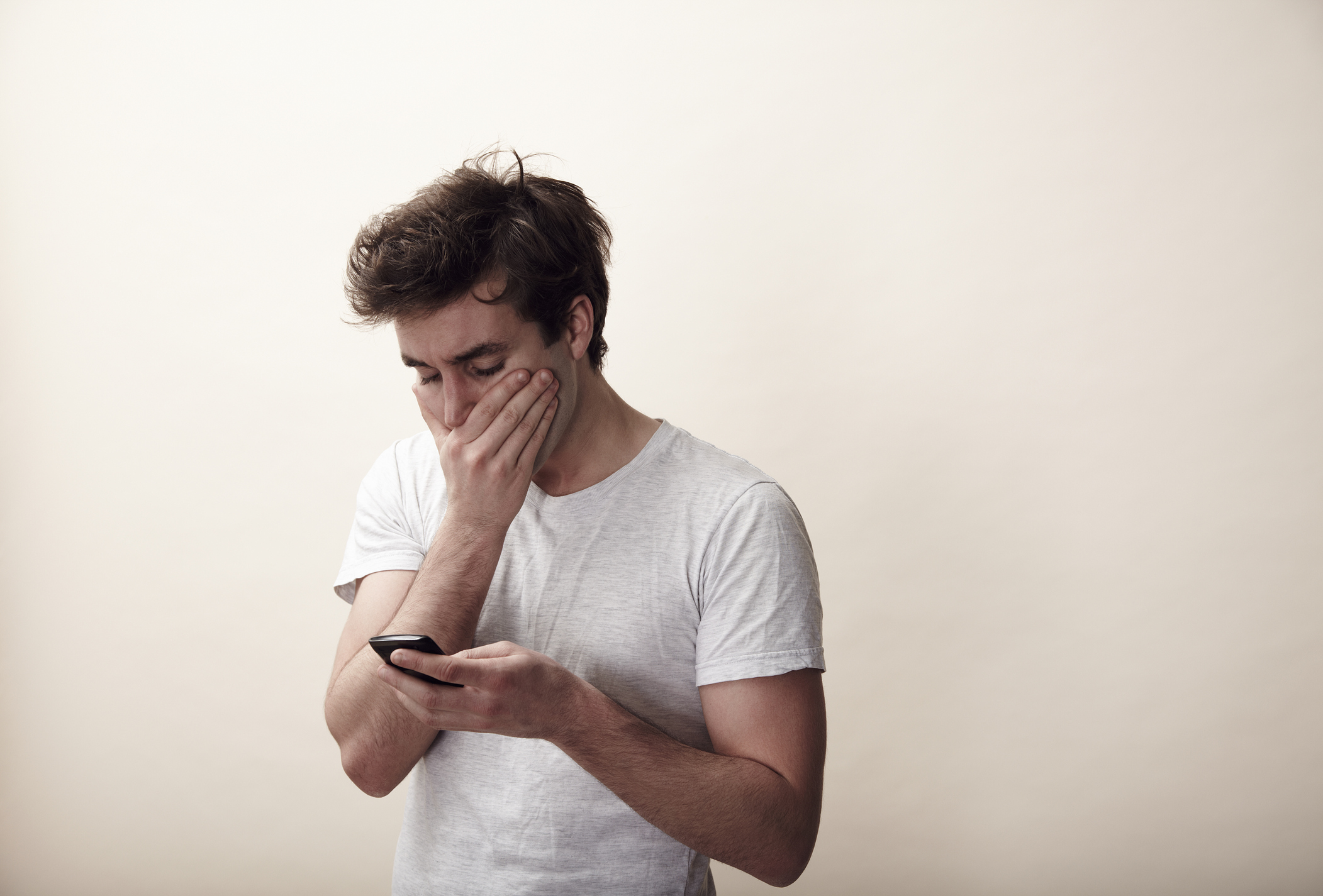 A man looks at his phone | Source: Getty Images