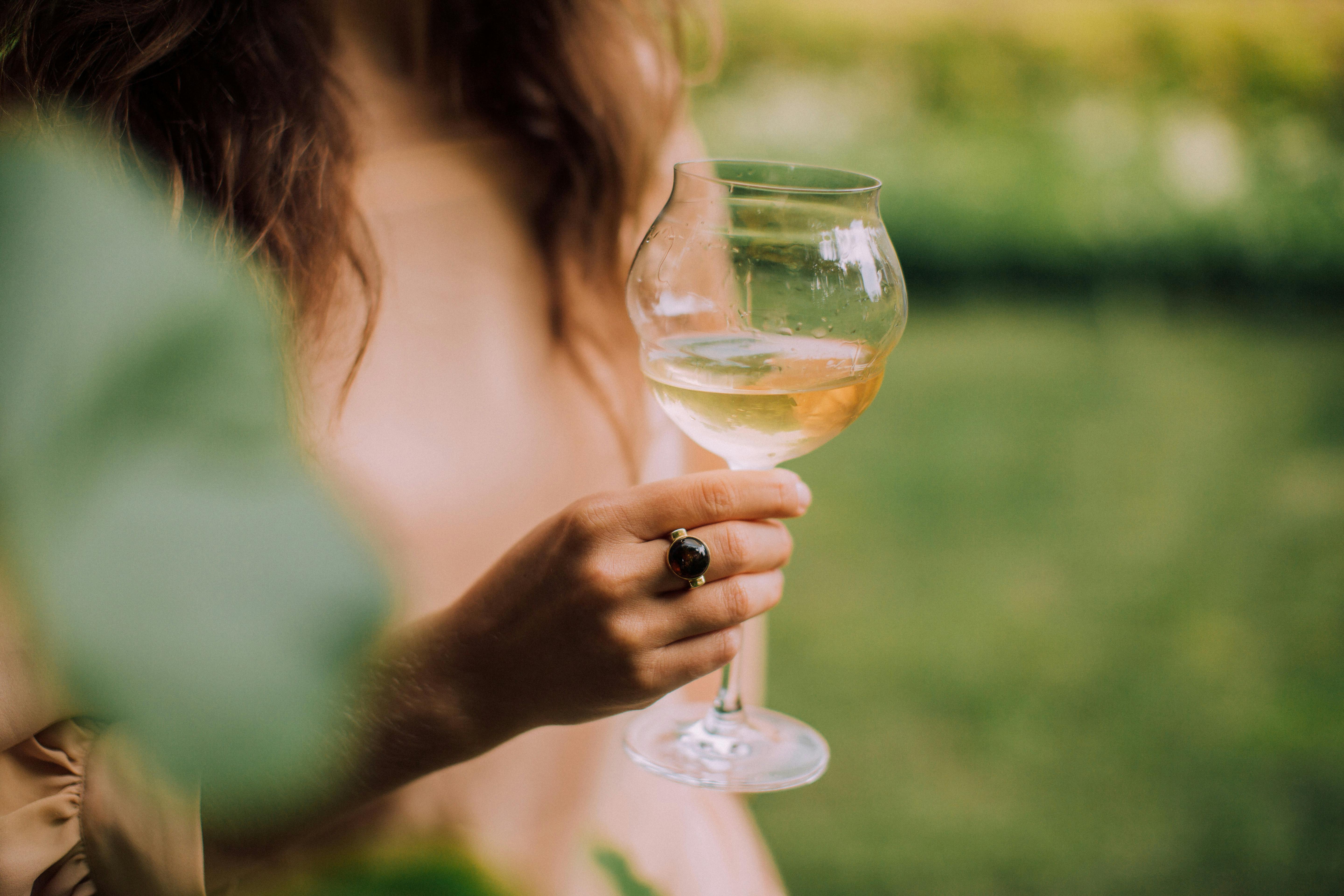 A woman holding a wine glass | Source: Pexels