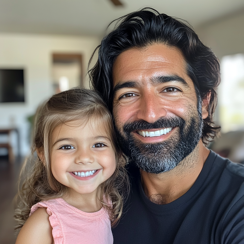 A smiling father and daughter | Source: no source