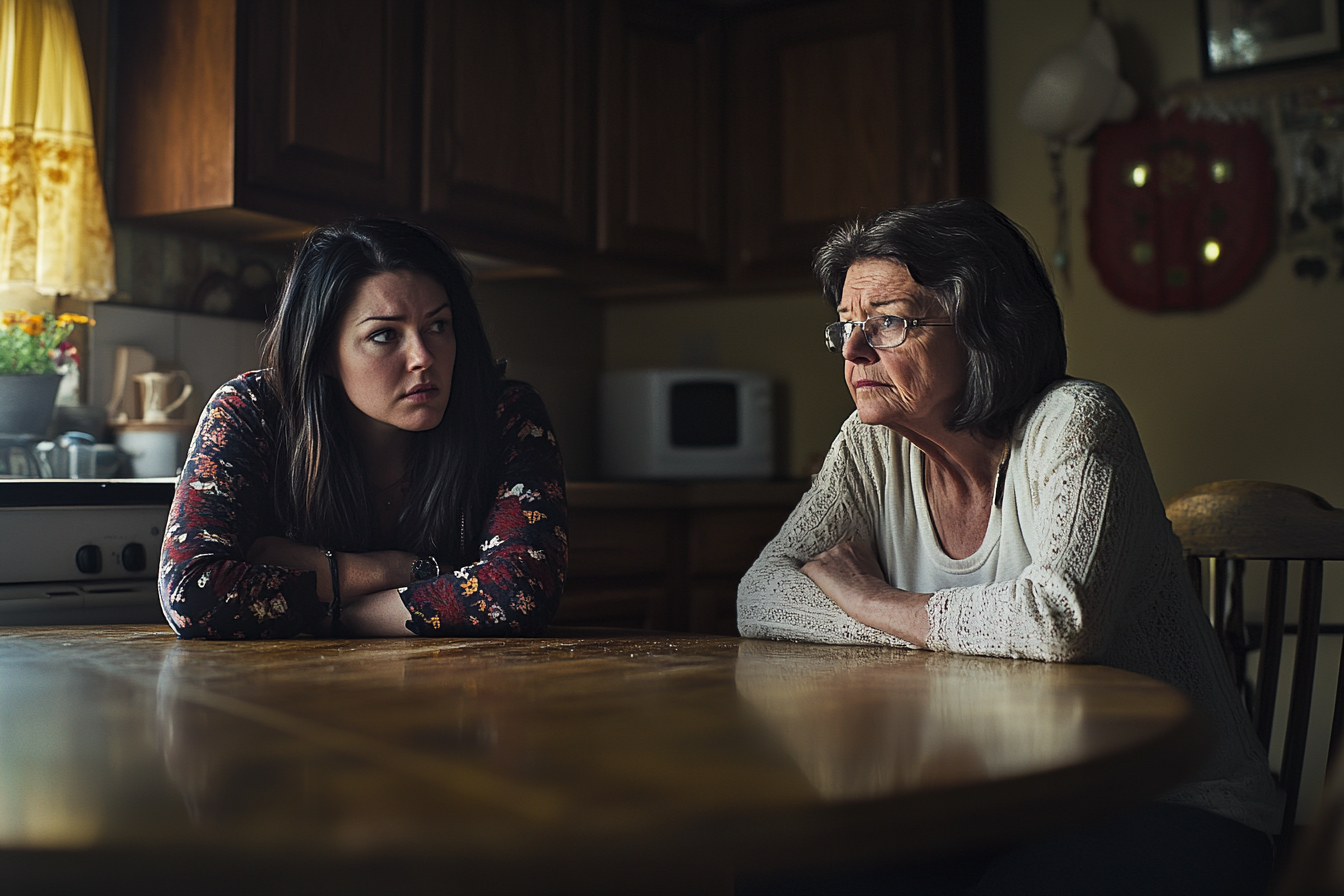 Two women sitting at a kitchen table | Source: No source
