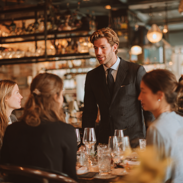 A man speaking to a group of women | Source: No source