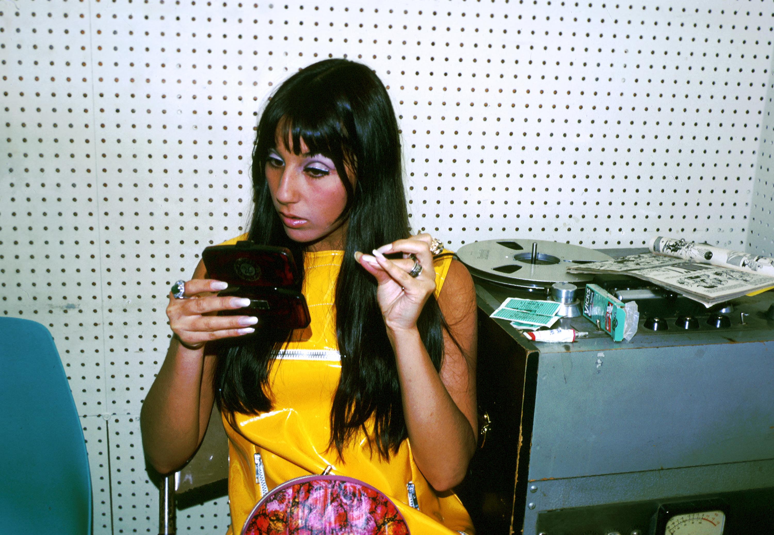 Cher checks her makeup during a recording session in Los Angeles, California in April 1966. | Source: Getty Images