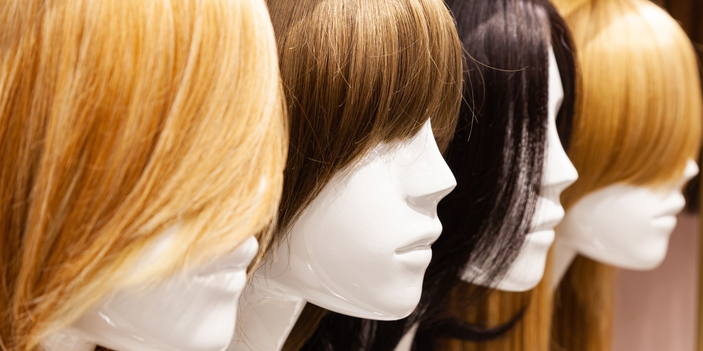 Multi-colored wigs on mannequins | Source: Shutterstock