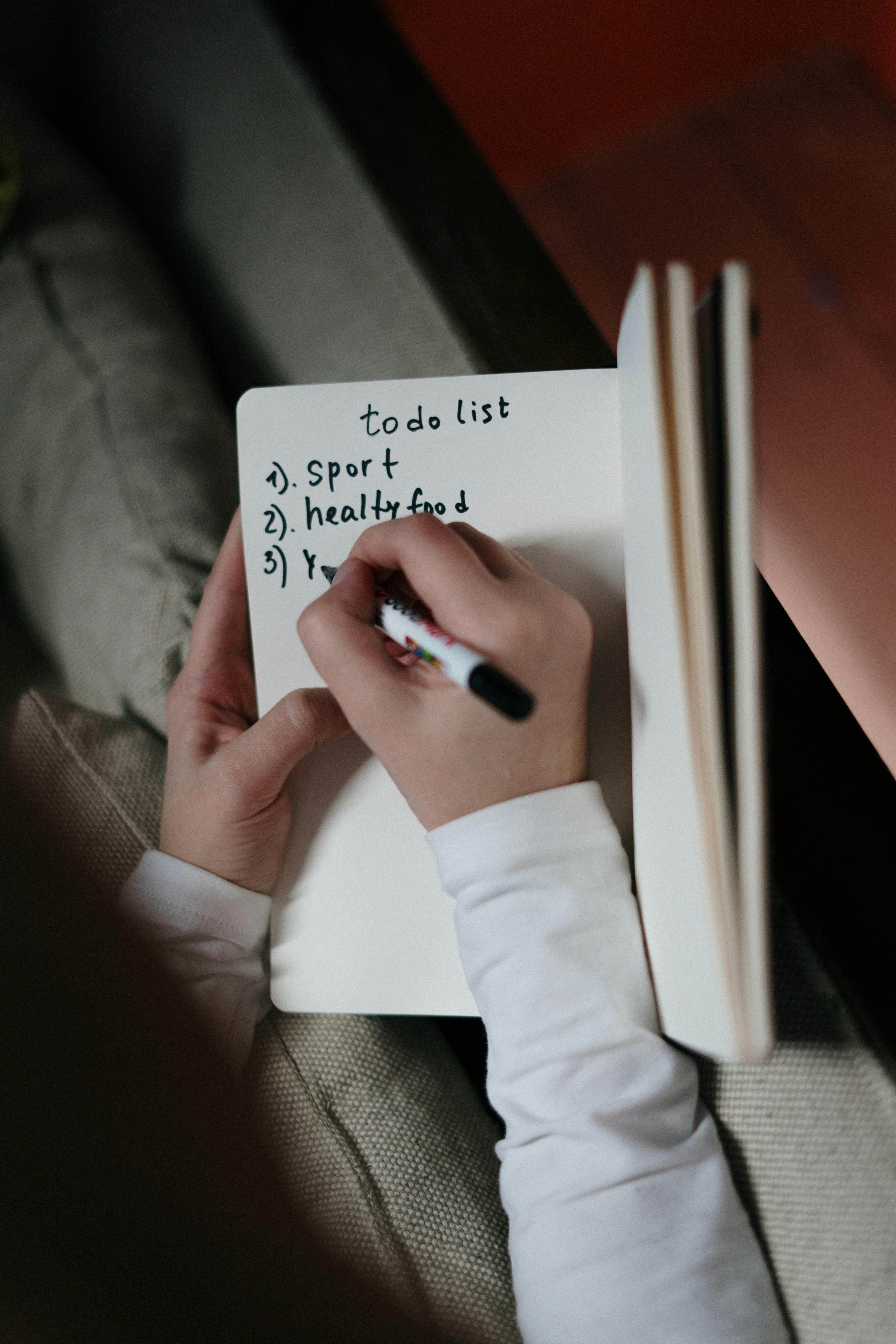 A person writing on a diary | Source: Pexels