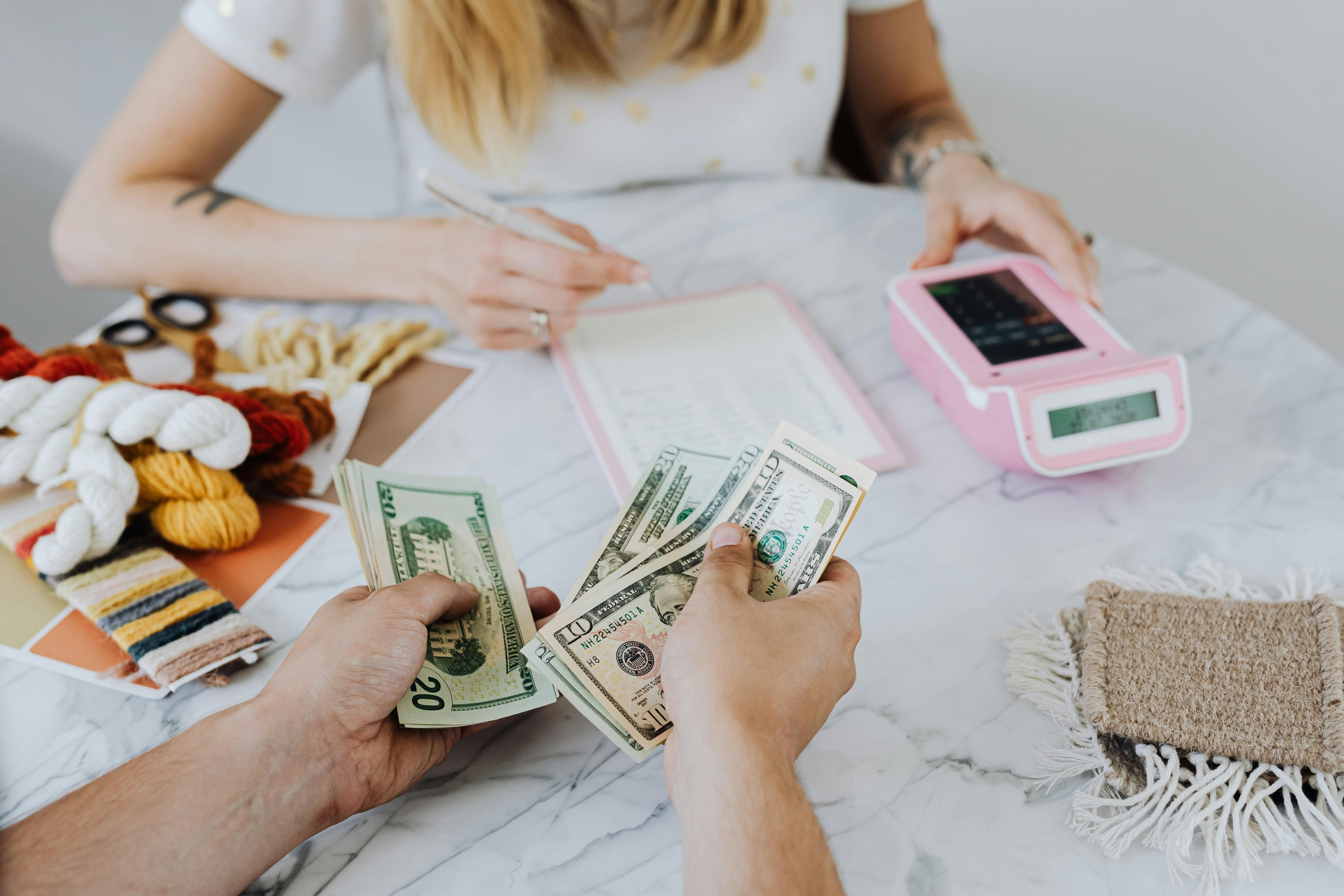 People counting money | Source: Pexels