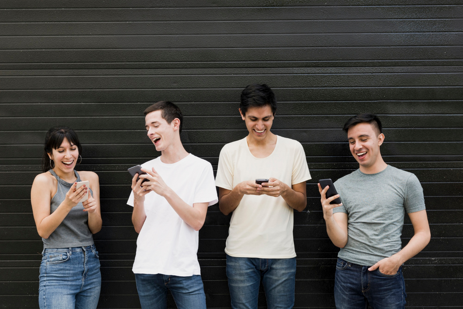 A group of excited people holding their mobile phones | Source: Freepik