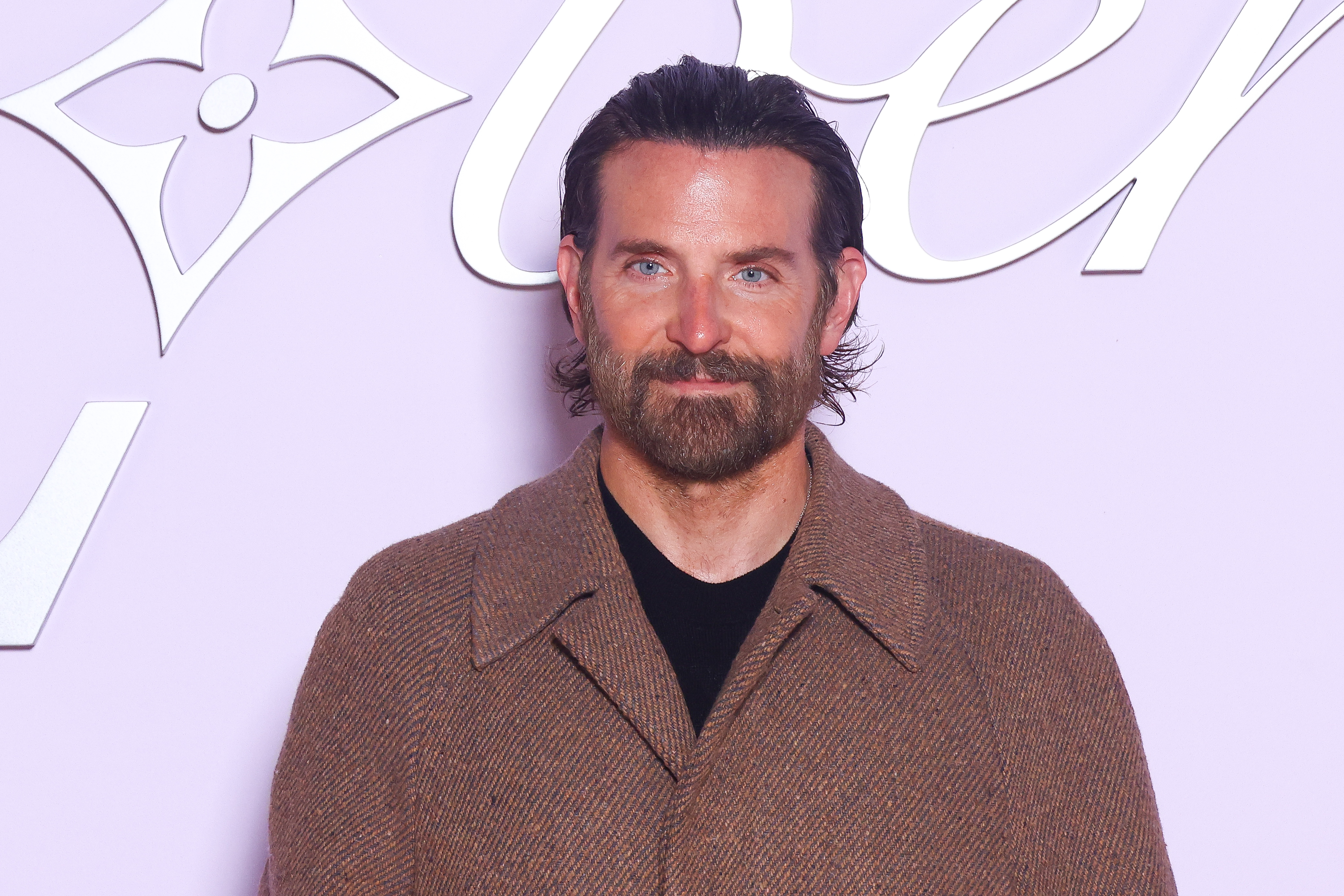 Cooper, now 50, maintained a calm expression with subtle lines etching his forehead and surrounding his eyes. He wore a full, well-groomed beard, showing a blend of brown and gray, as he attended the Louis Vuitton Menswear Fall-Winter 2025/2026 show as part of Paris Fashion Week on January 21, 2025, in Paris, France.