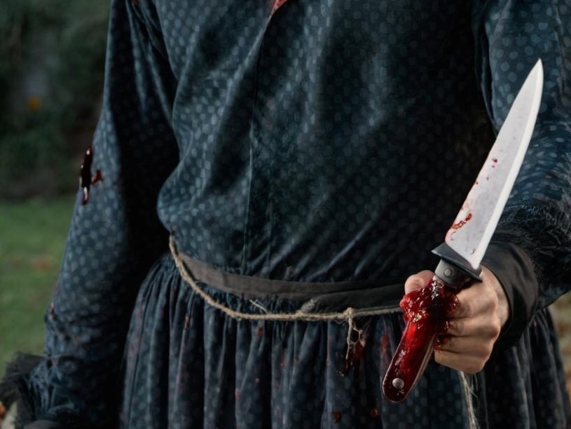 A hand holding a "bloody" knife | Source: No source