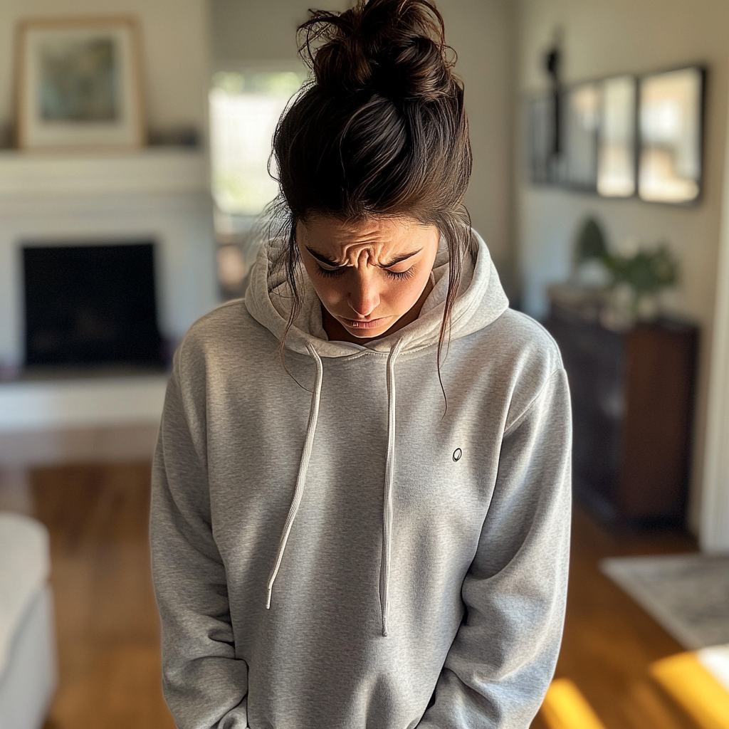 A woman with a messy bun and a hoodie | Source: No source