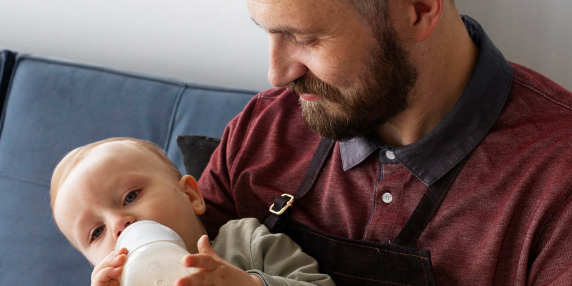 A man feeding a baby | Source: Freepik