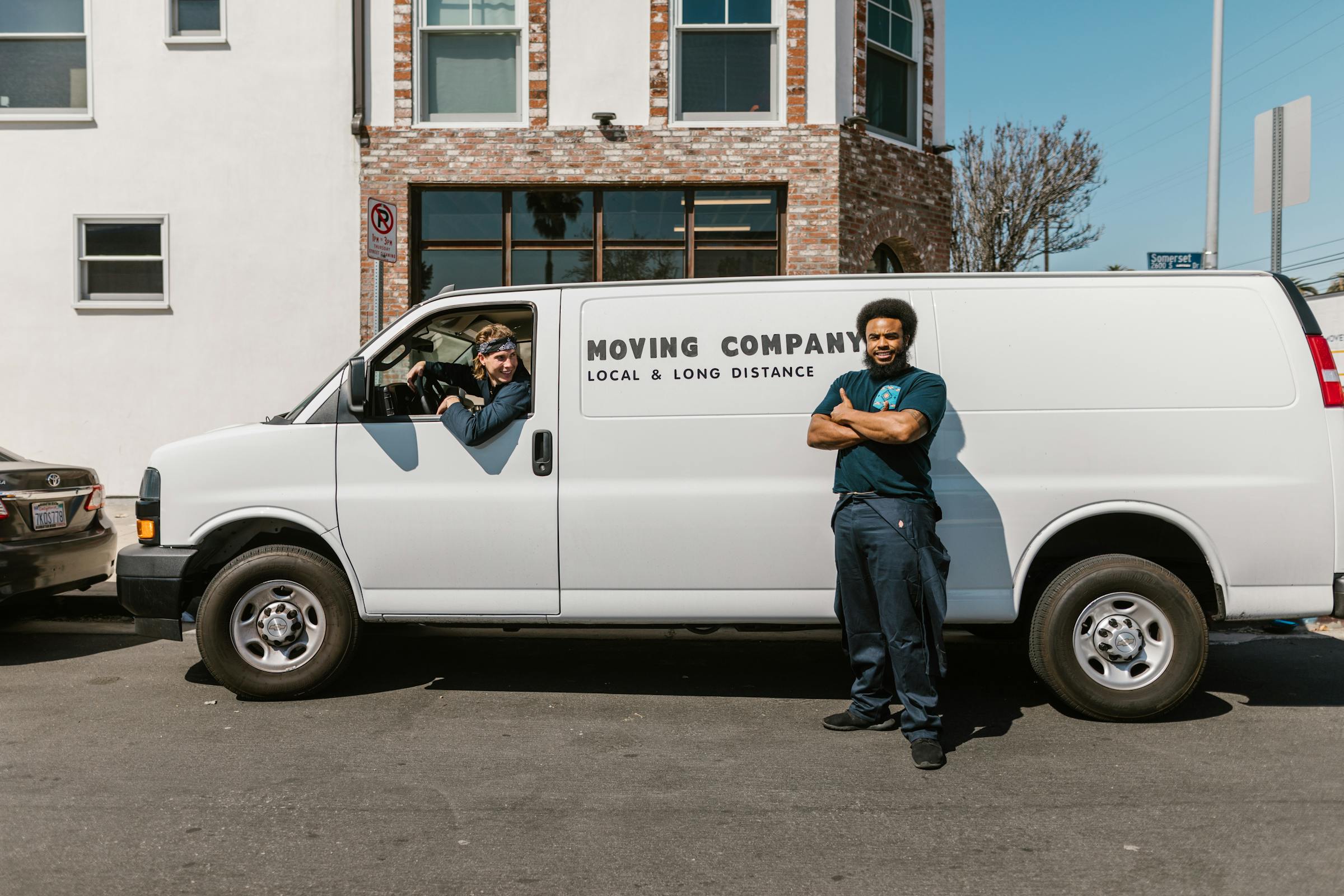 Workers from a moving company with their van | Source: Pexels