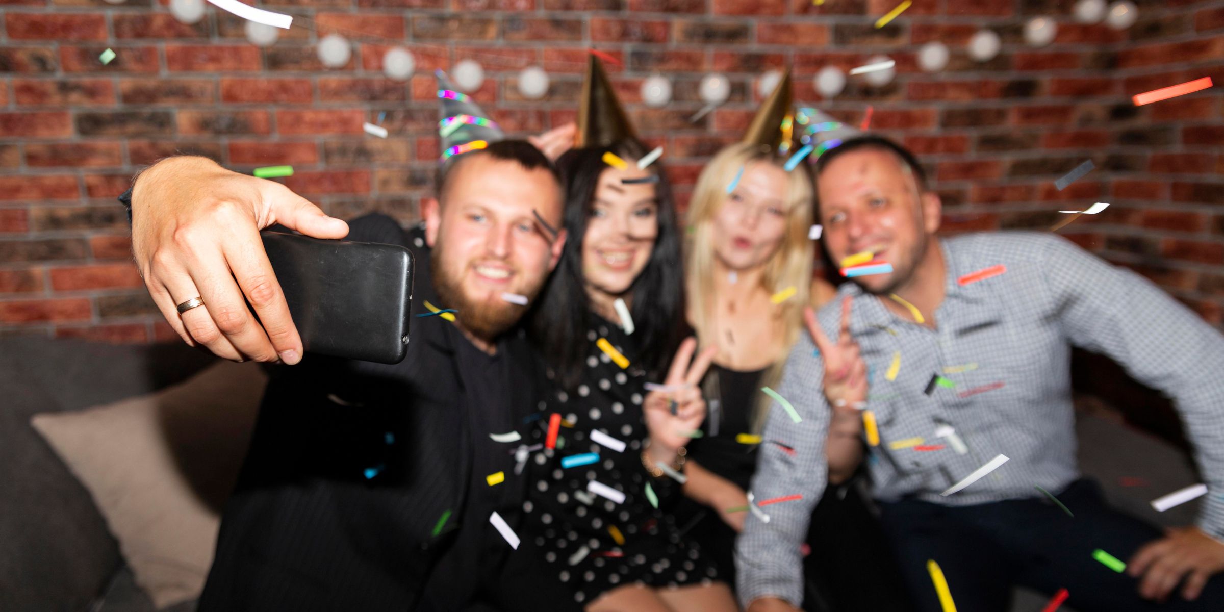 Party guests happily posing for pictures | Source: No source