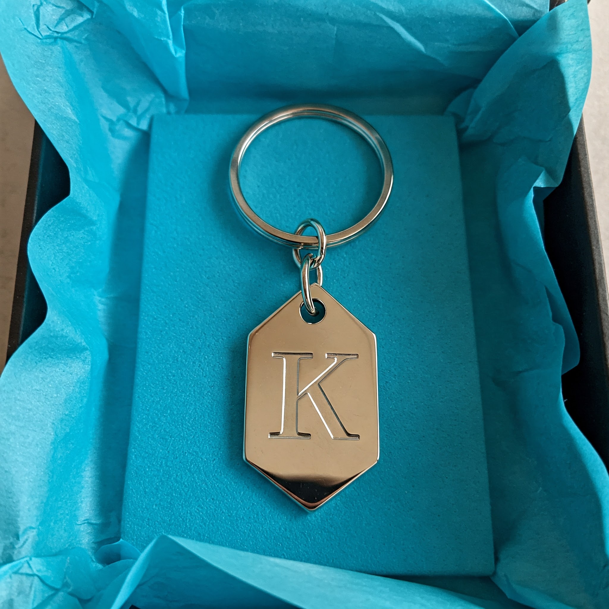 A silver keychain in a gift box | Source: no source