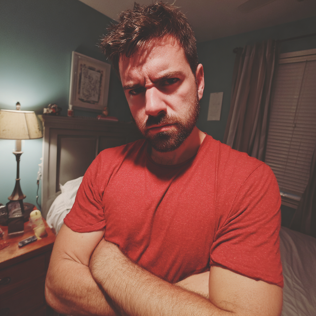 An angry man standing with folded arms | Source: no source