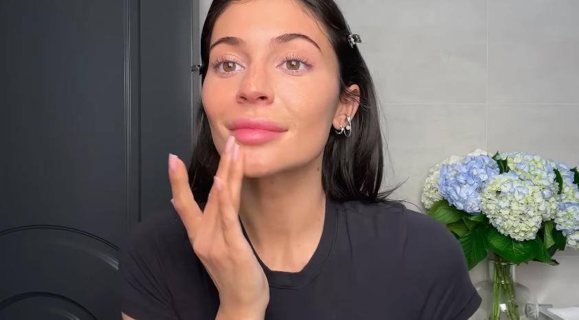 Kylie Jenner doing her classic beauty routine from a video dated April 6, 2023. | Source: YouTube/Vogue