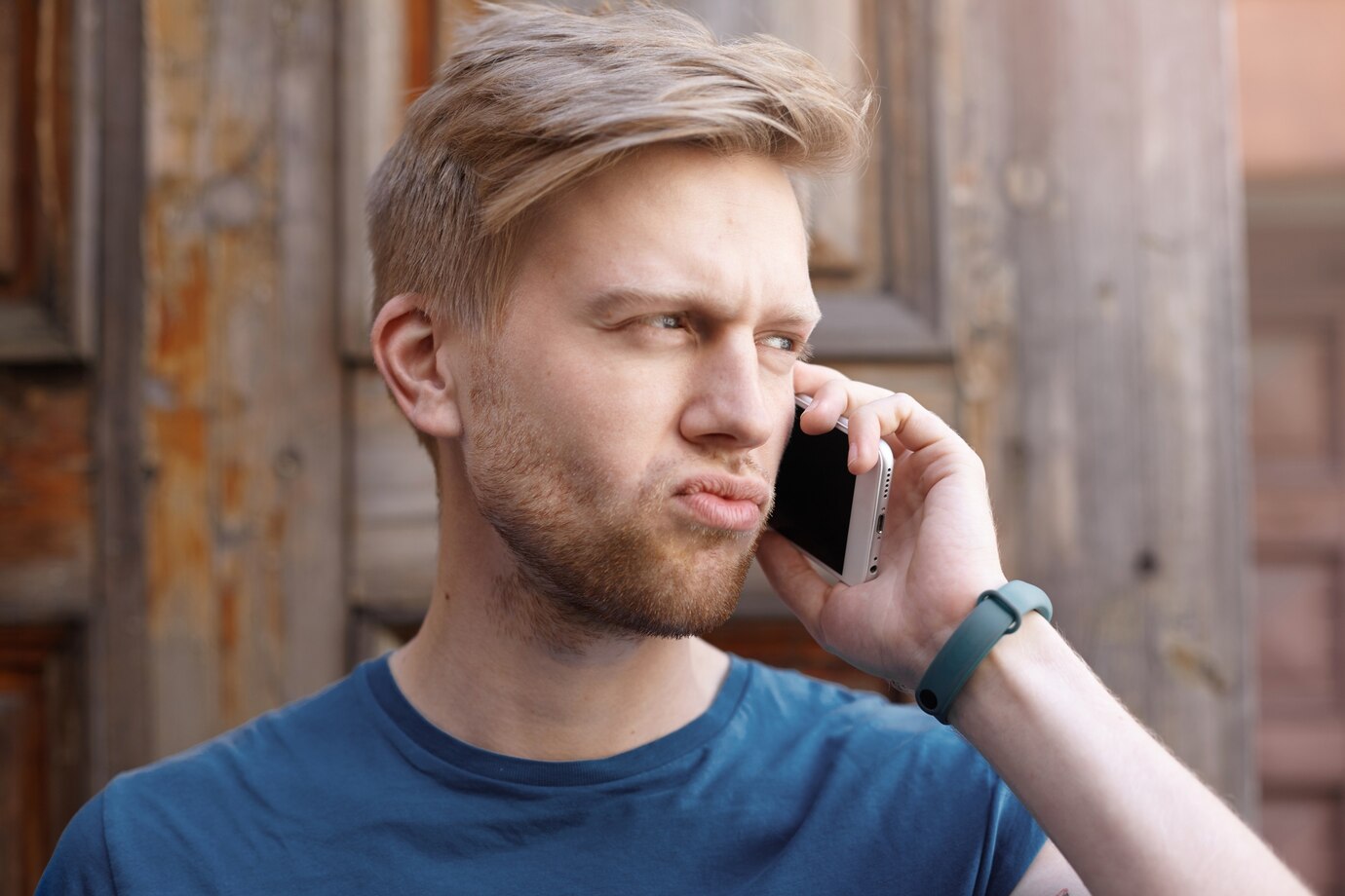 An annoyed man talking on his phone | Source: Freepik