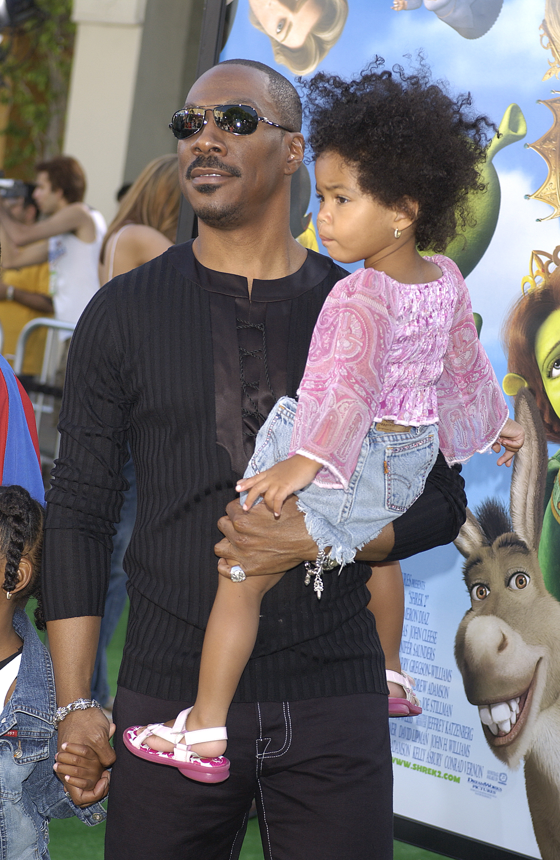 Eddie Murphy holding his daughter, Bella Murphy, during the Los Angeles premiere of "Shrek 2" at Mann Village Theatre on May 8, 2004. | Source: Getty Images