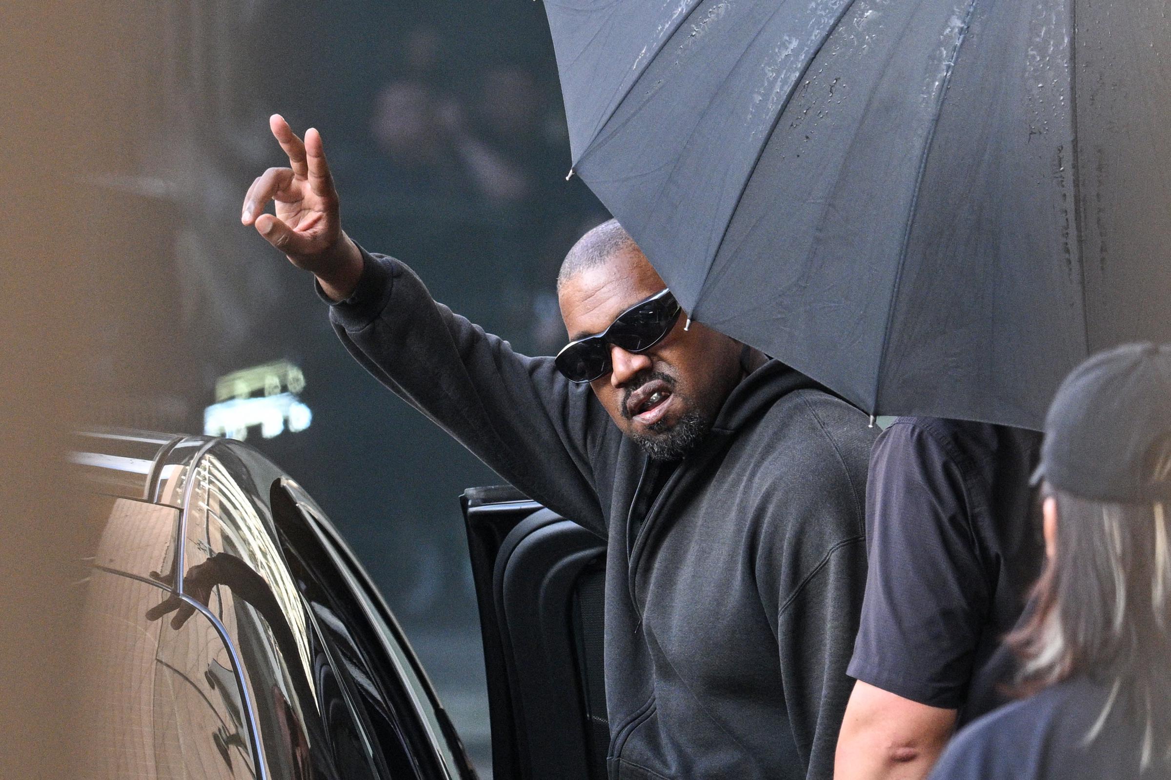 Kanye West gestures upon arriving at Shanghai Pudong International Airport on July 11, 2025, in Shanghai, China | Source: Getty Images