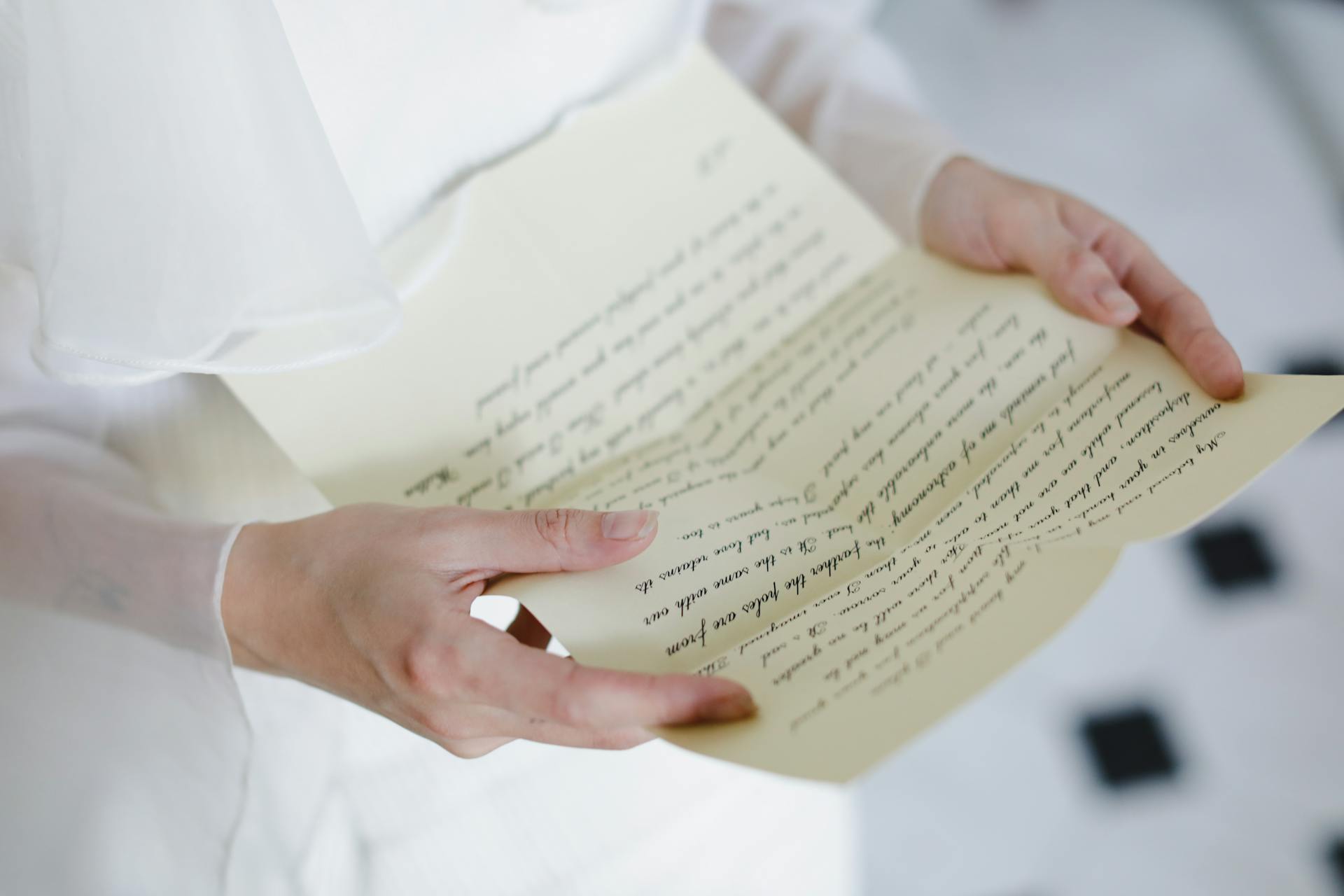 A woman holding a paper | Source: No source