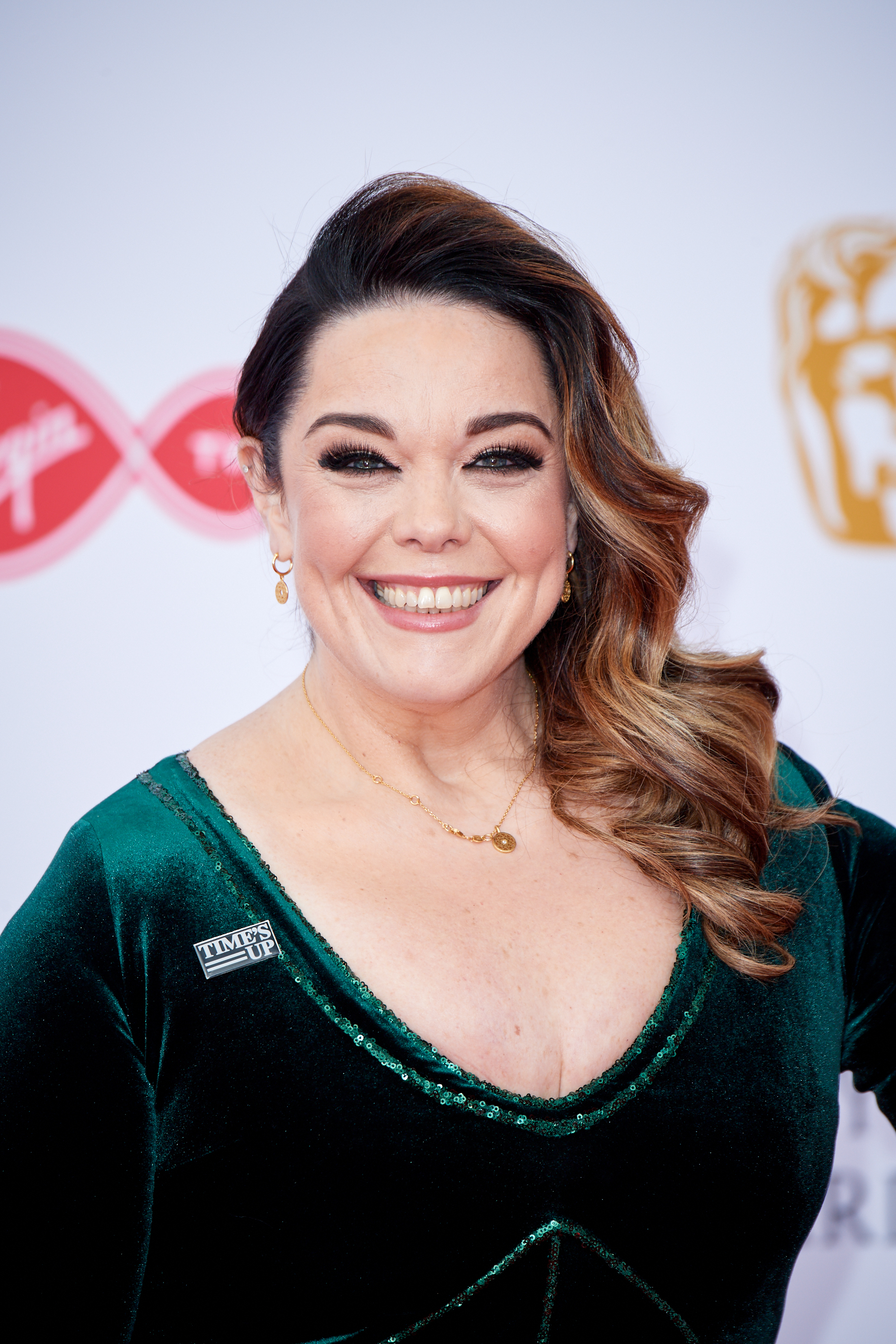 Emerald elegance! Riley stuns in a luxurious velvet gown at the Virgin TV BAFTAs on 13 May 2018, commanding the red carpet at Royal Festival Hall while proudly supporting the Time’s Up movement with a statement pin.