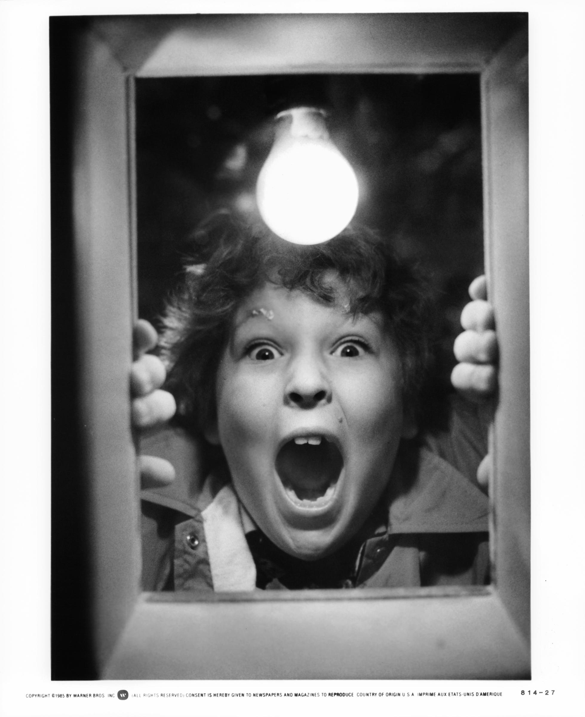Jeff Cohen shouting through a hole in the door, in a scene from the film "Goonies," in 1985 | Source: Getty Images