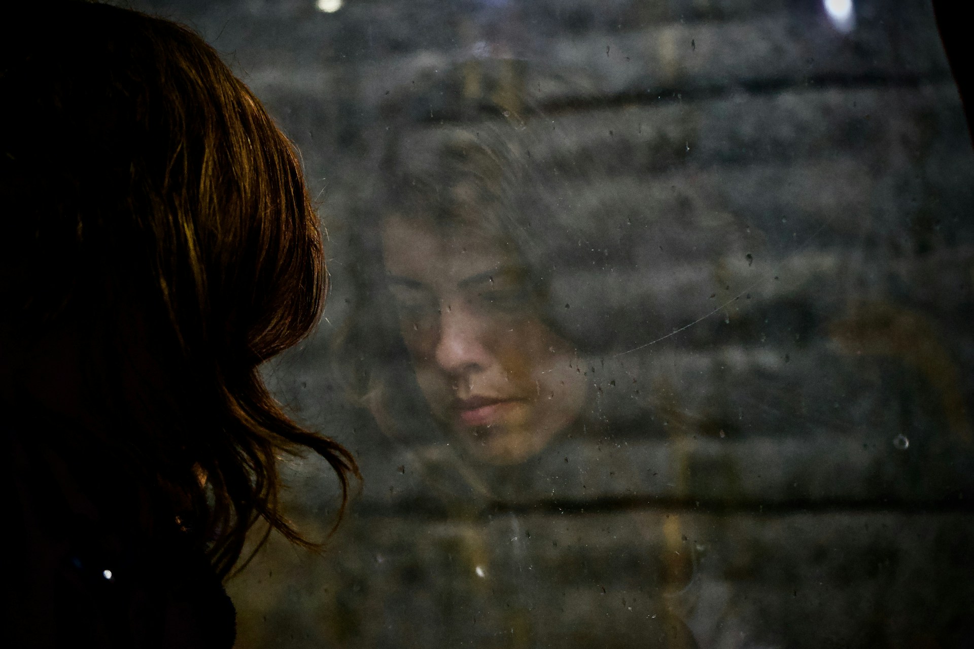 A woman staring out a window | Source: Unsplash