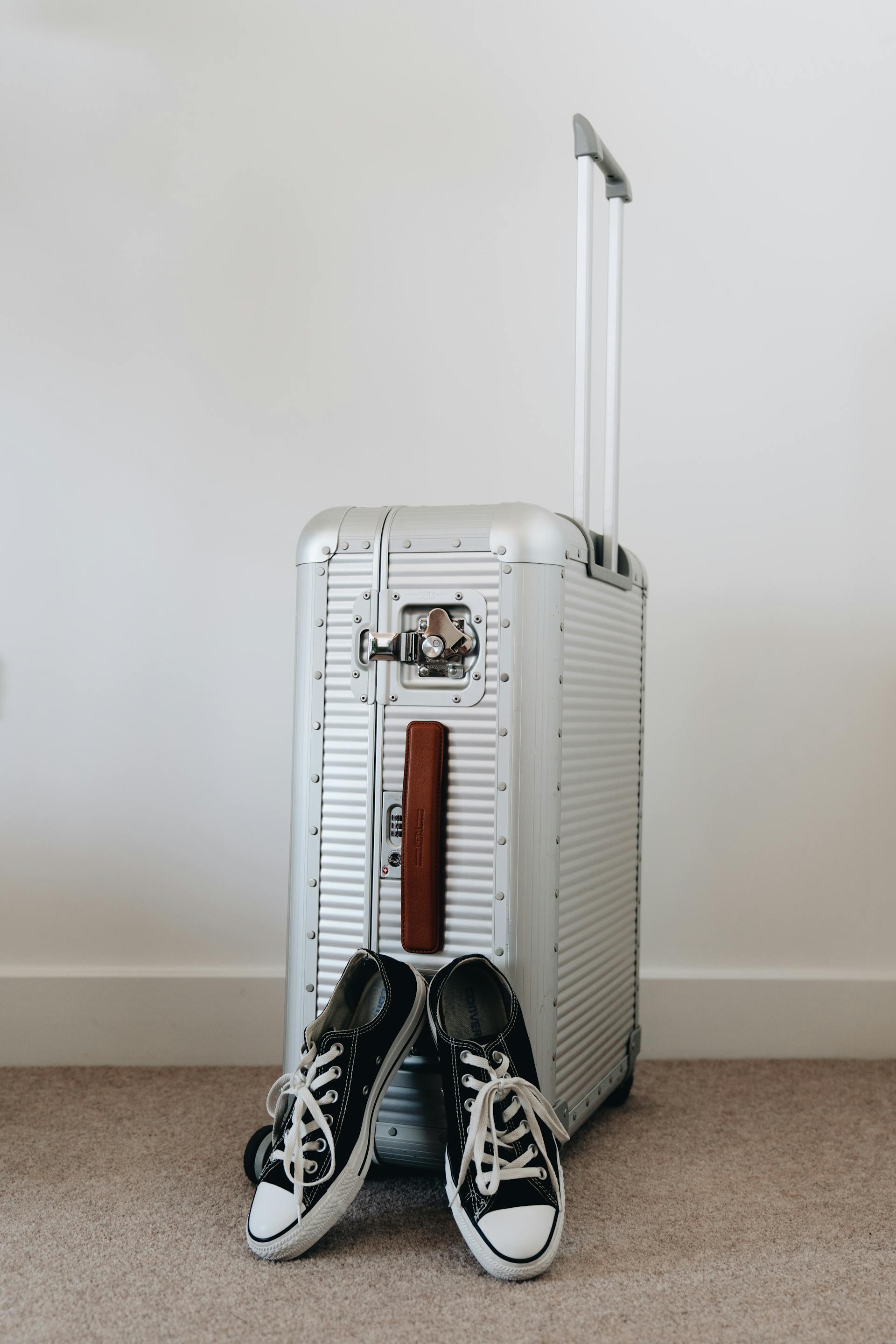 A suitcase and a pair of sneakers | Source: Pexels