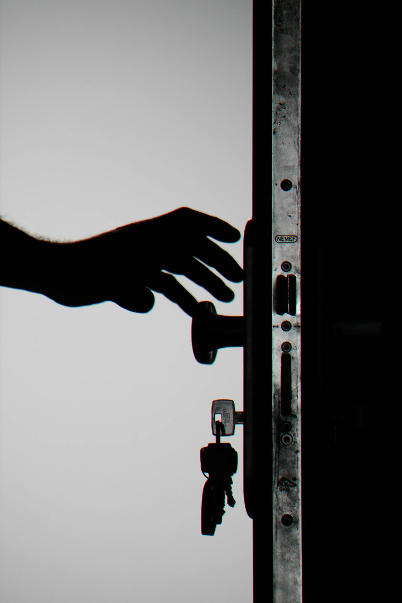 Silhouette of a person reaching out for a doorknob | Source: Pexels