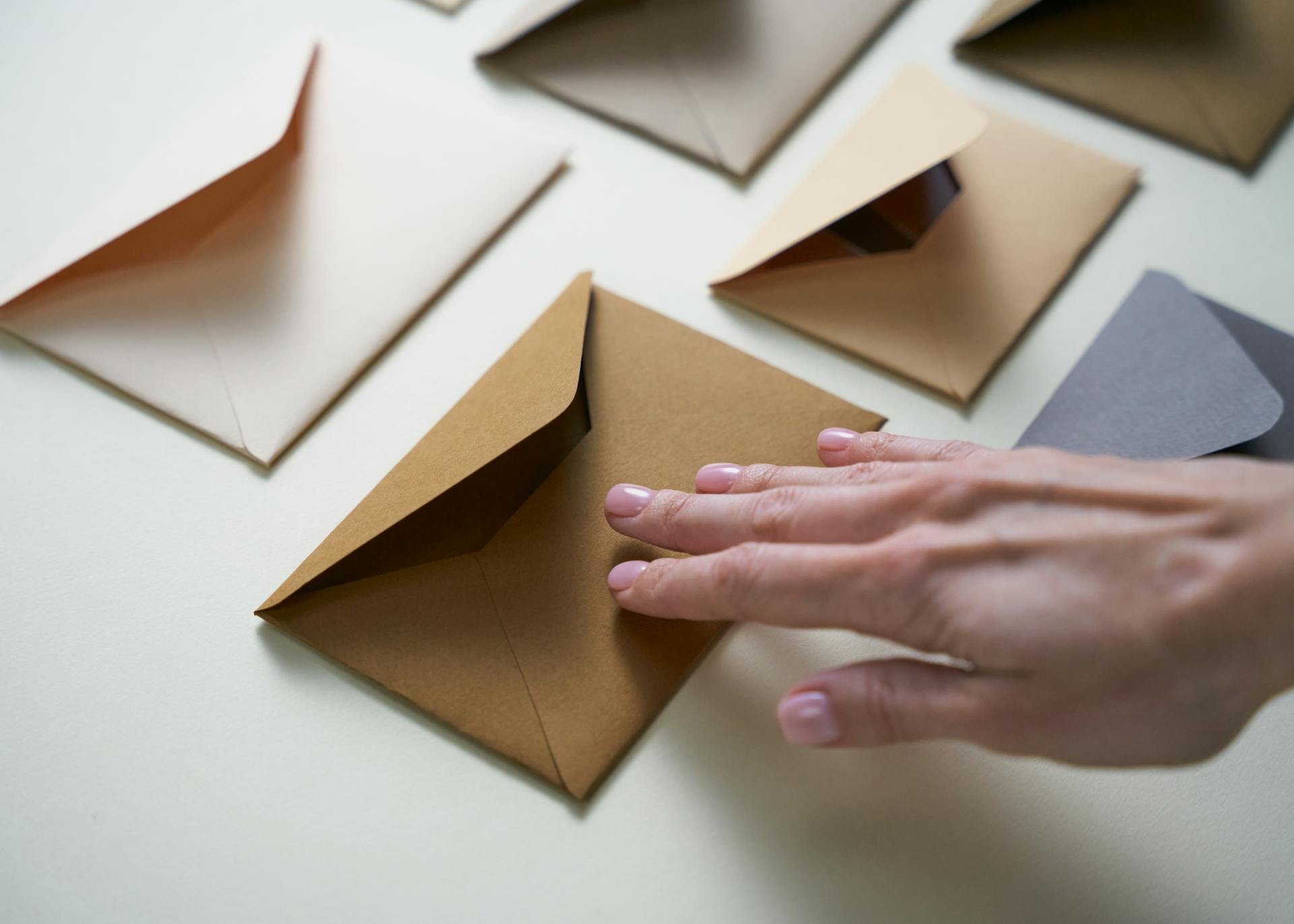 A woman reaching for an envelope | Source: Pexels