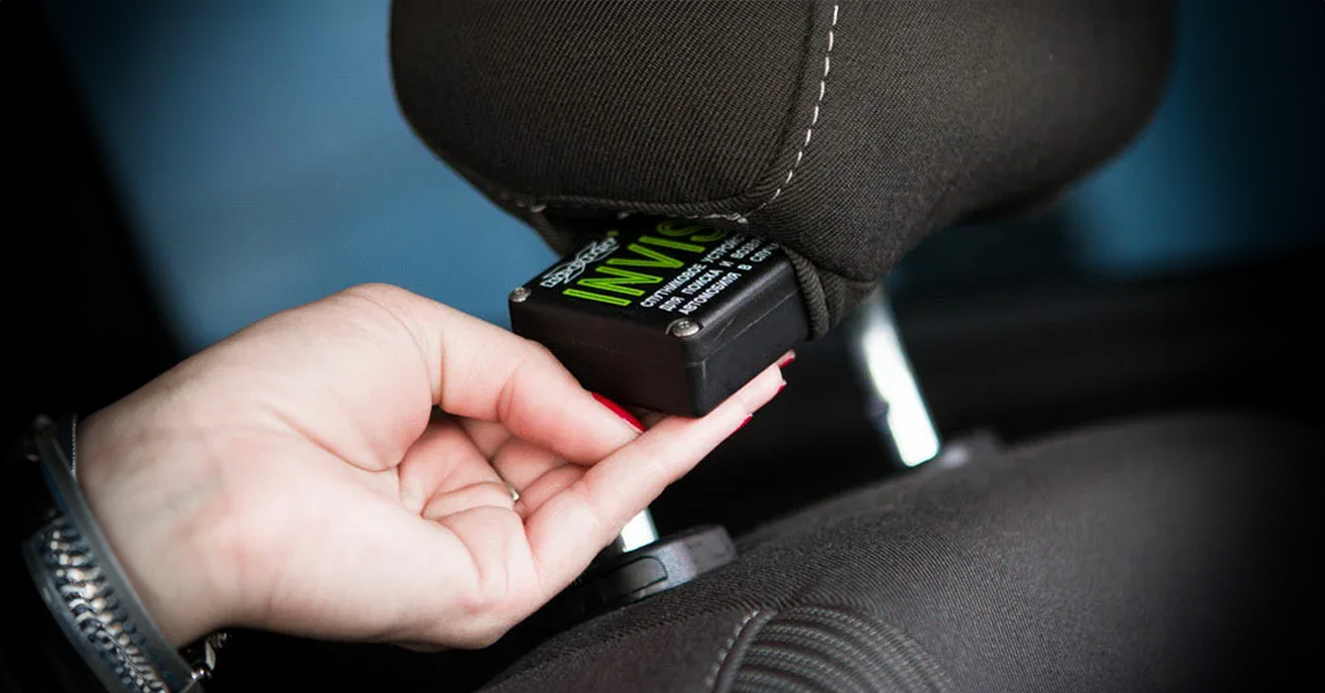Woman places a recorder in the driver's seat | Source: Shutterstock